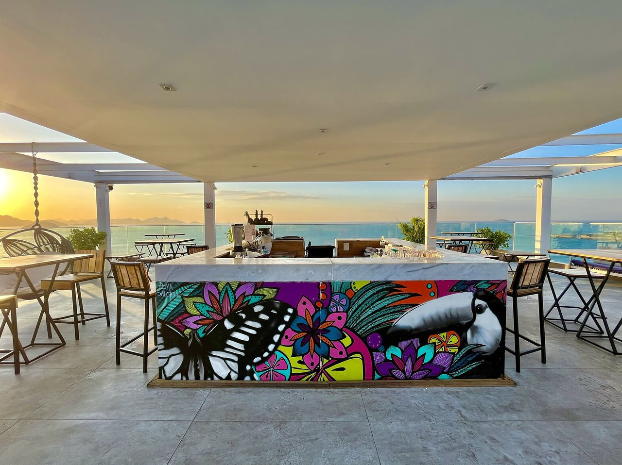 O bar Deck, do Hotel 4 Estrelas no Rio de Janeiro, serve bebidas como cocktails e tem mesas com vista para o mar