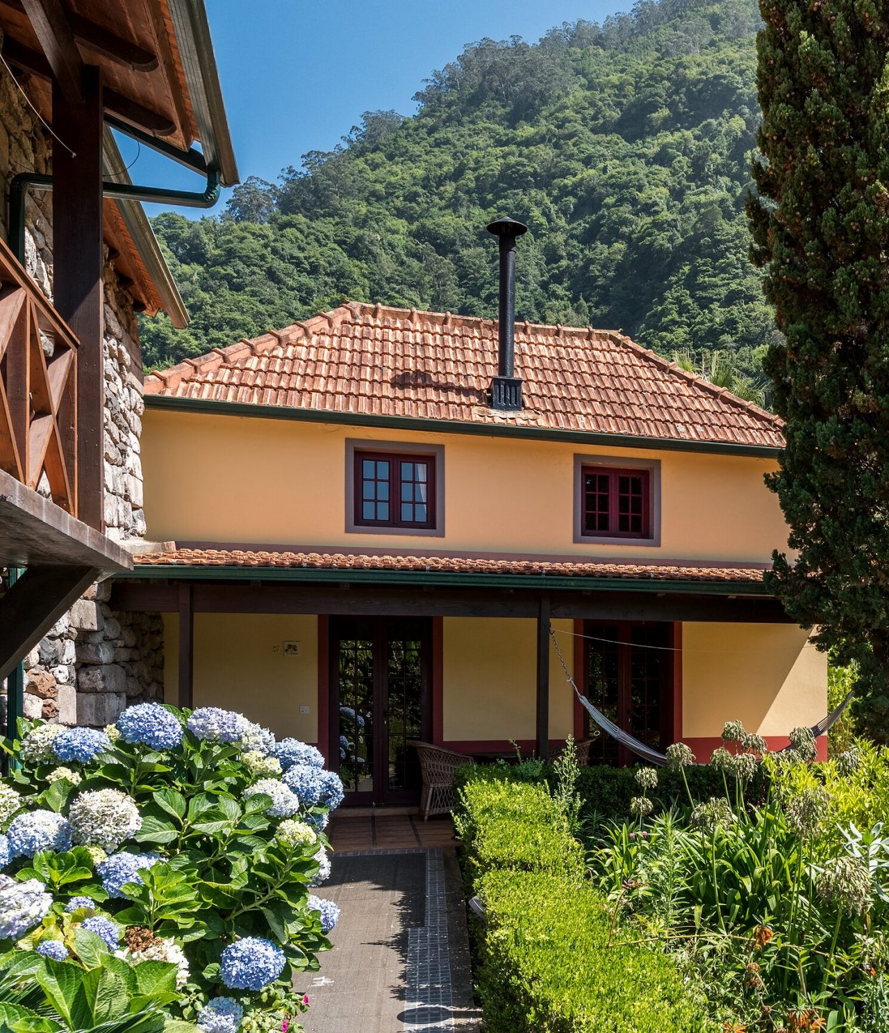O restaurante Roseiral, do Turismo Rural na Madeira, está localizado no meio da naturezam com jardim e montanhas ao fundo