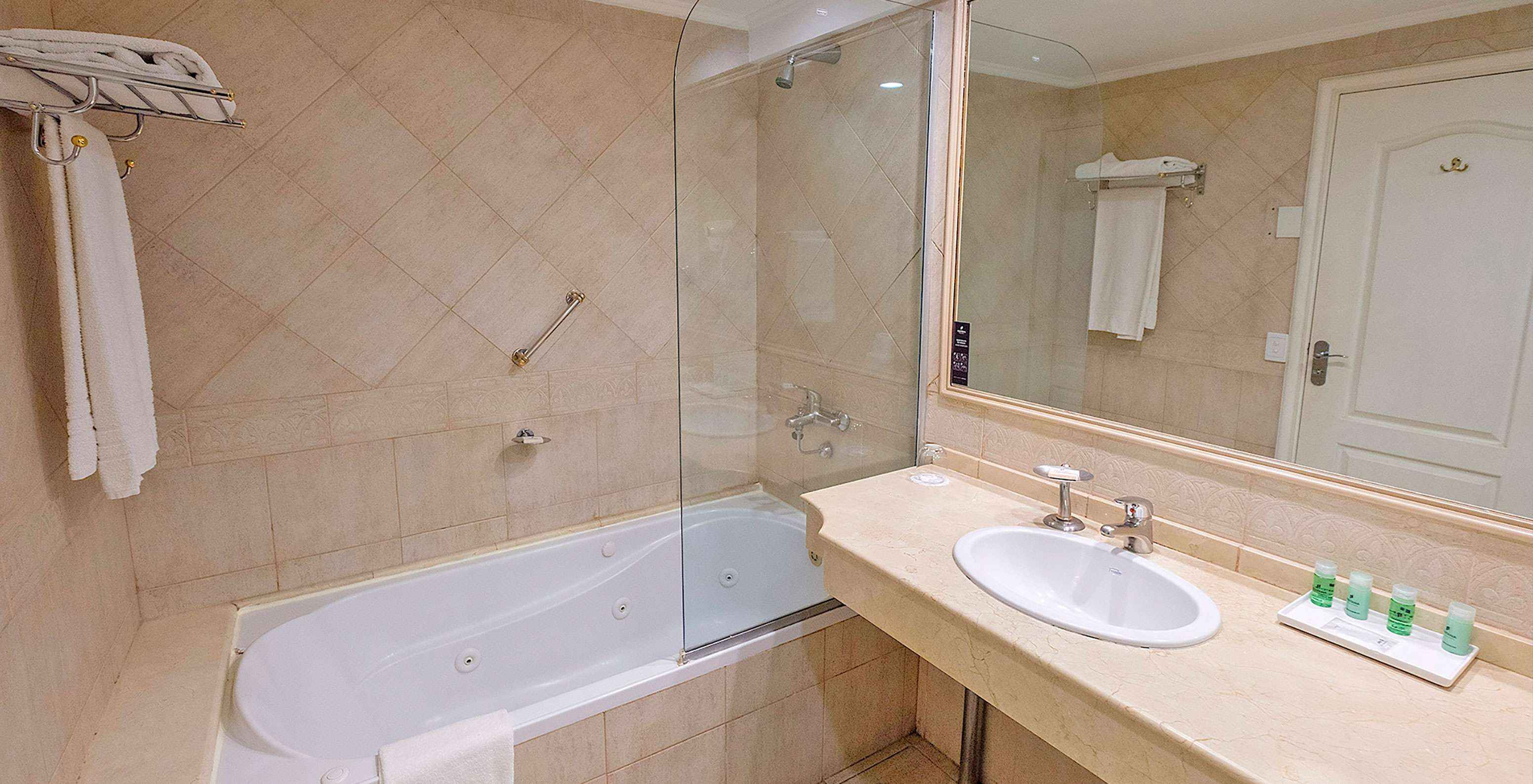The Twin Superior at Pestana Buenos Aires has a bathroom with a sink, mirror, and a bathtub with a shower