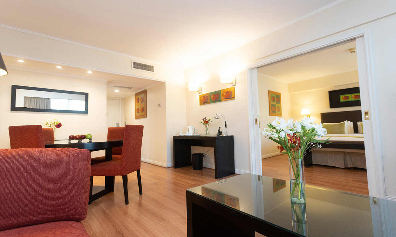 The Suite at Pestana Buenos Aires has a table with chairs, a mirror, phone, and coffee table