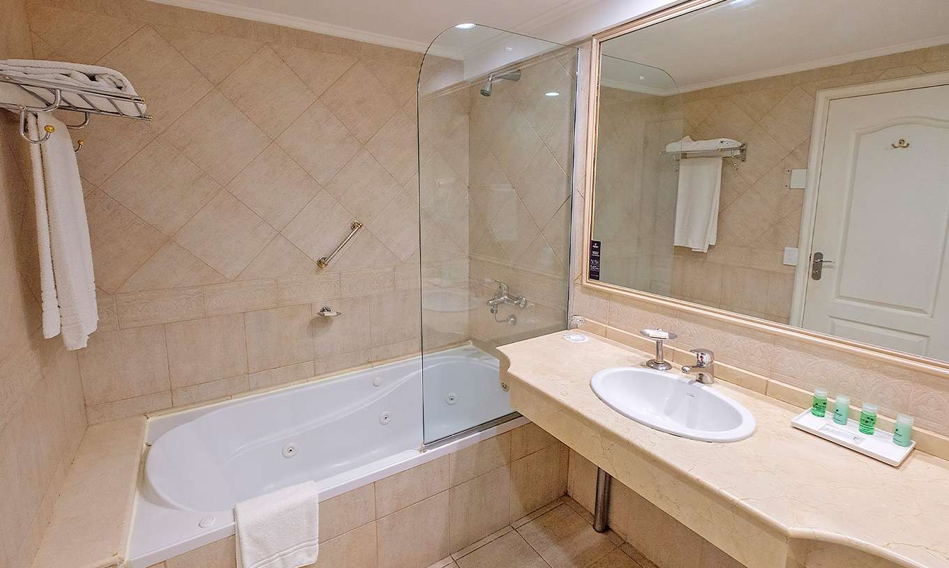 The Twin Superior at Pestana Buenos Aires has a bathroom with a sink, mirror, and a bathtub with a shower