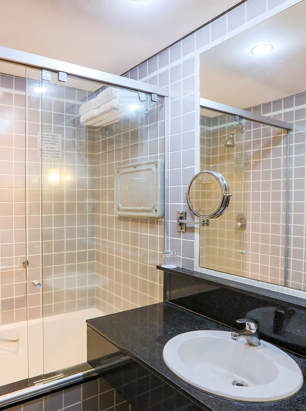 The Family Room at Pestana Curitiba has a bathroom with a bathtub and a black countertop with a sink