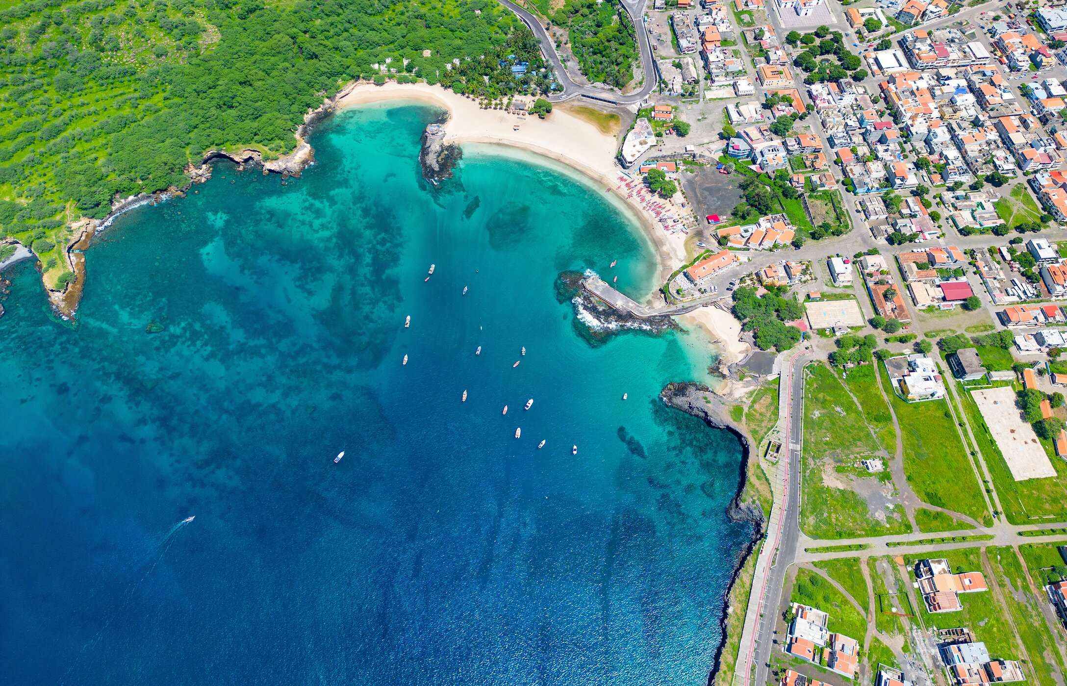 Aerial view of Tarrafal Beach in Cape Verde, with its crystal-clear waters, white sand, and surrounding vegetation