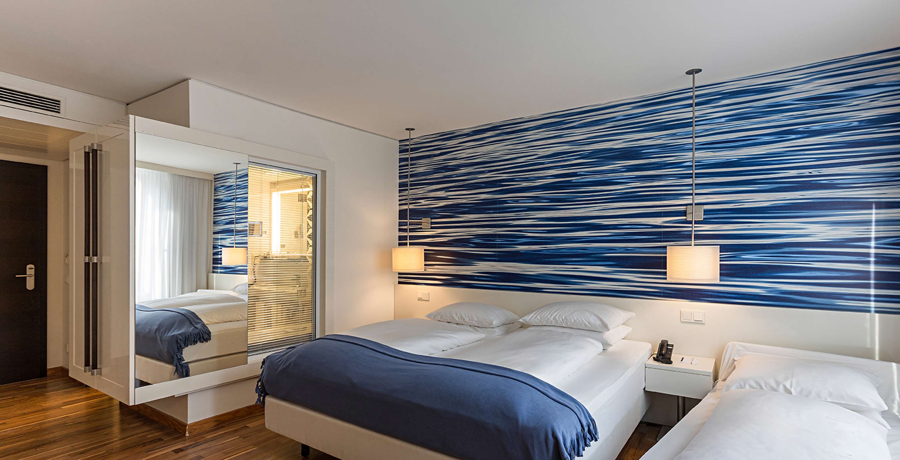 Family Deluxe is a spacious room with blue-toned decor