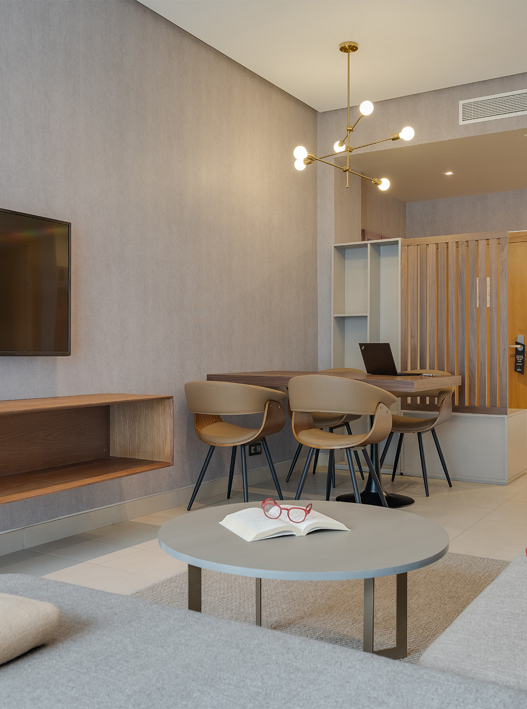 The Suite at Pestana Casablanca has a comfortable sofa with chaise longue, a satellite TV, and a kitchenette