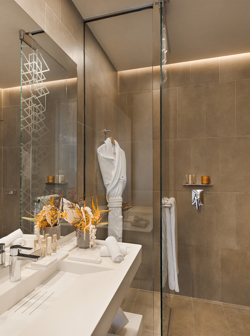 The CR7 Room at Pestana CR7 Marrakech has a bathroom with a walk-in shower, sink with mirror, and various amenities
