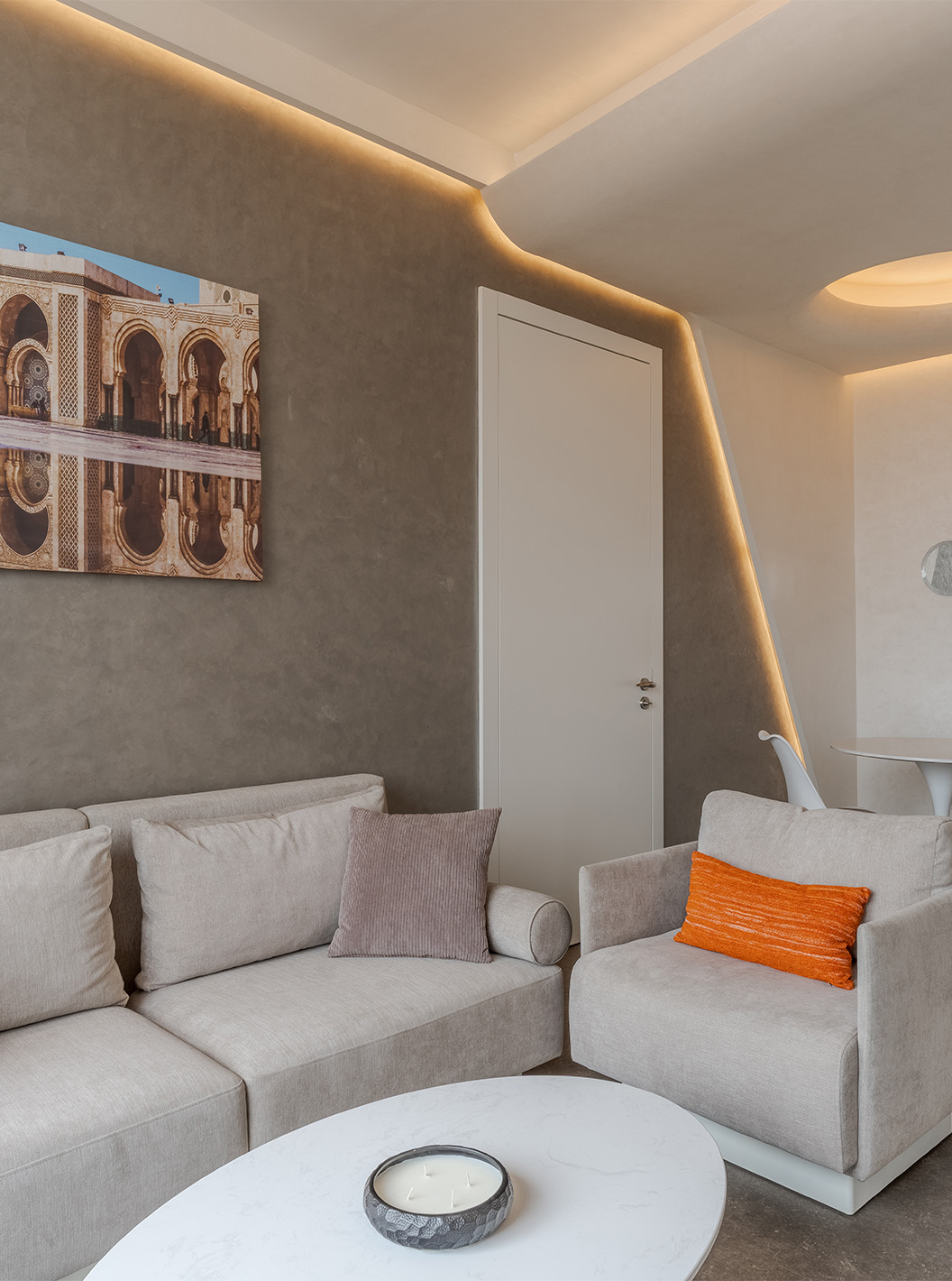 The CR7 Suite at Pestana CR7 Marrakech has a living room with two sofas, a painting, and a dining table