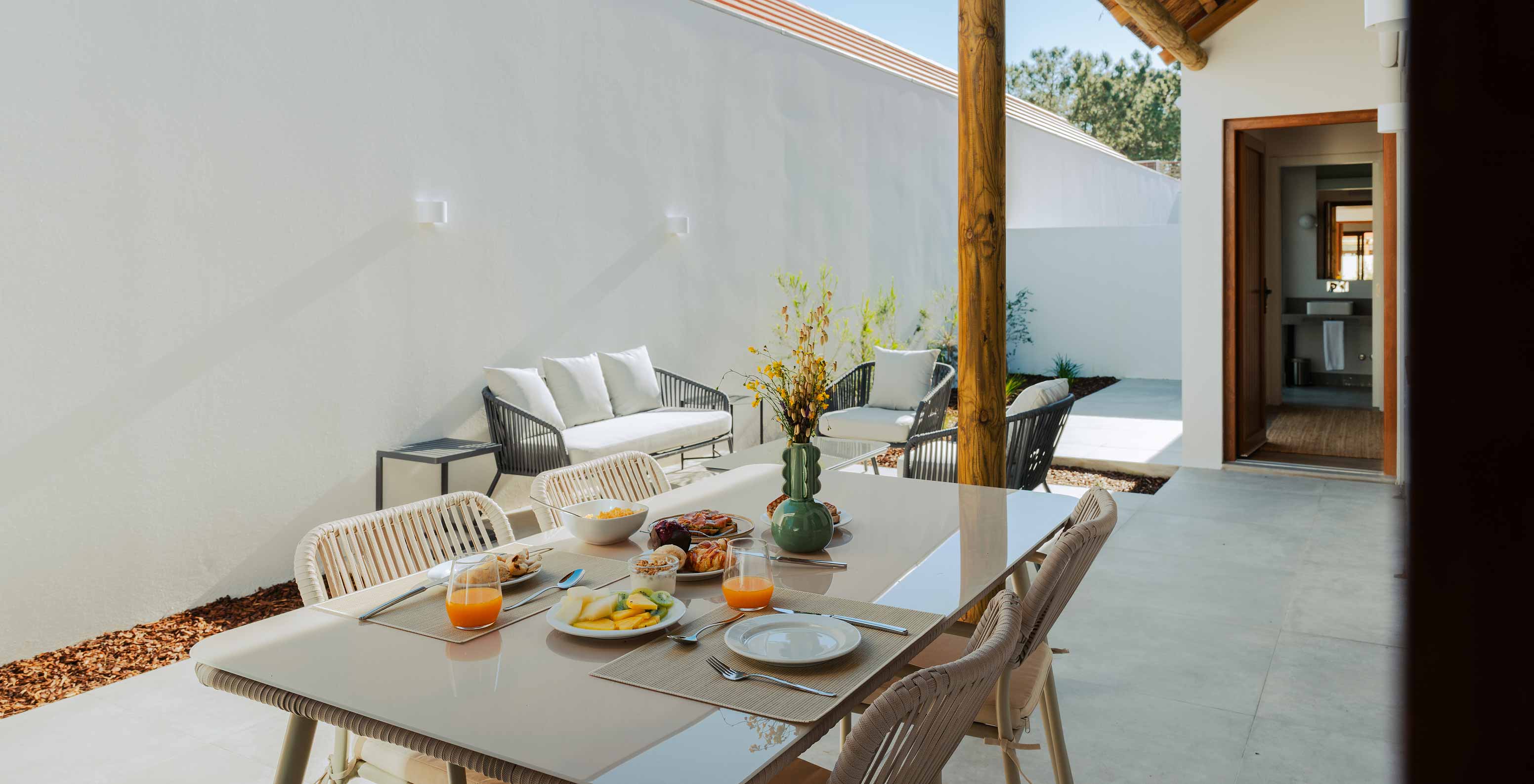 The Superior Villa at Pestana Comporta Village Residences has an outdoor patio with a dining table and a sofa