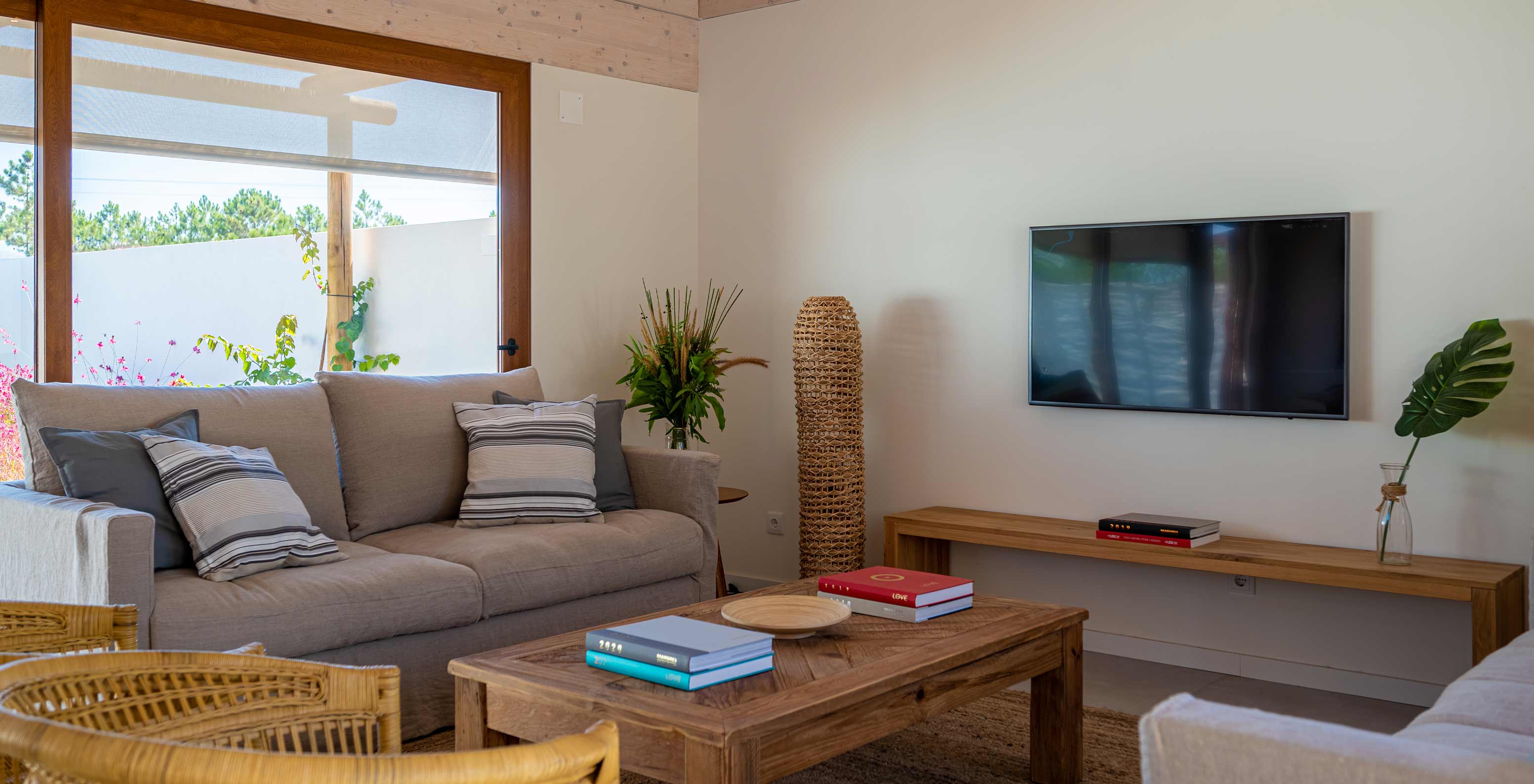 The Standard Villa T1 at Pestana Comporta Village Residences has a living room with a sofa and a TV on the wall