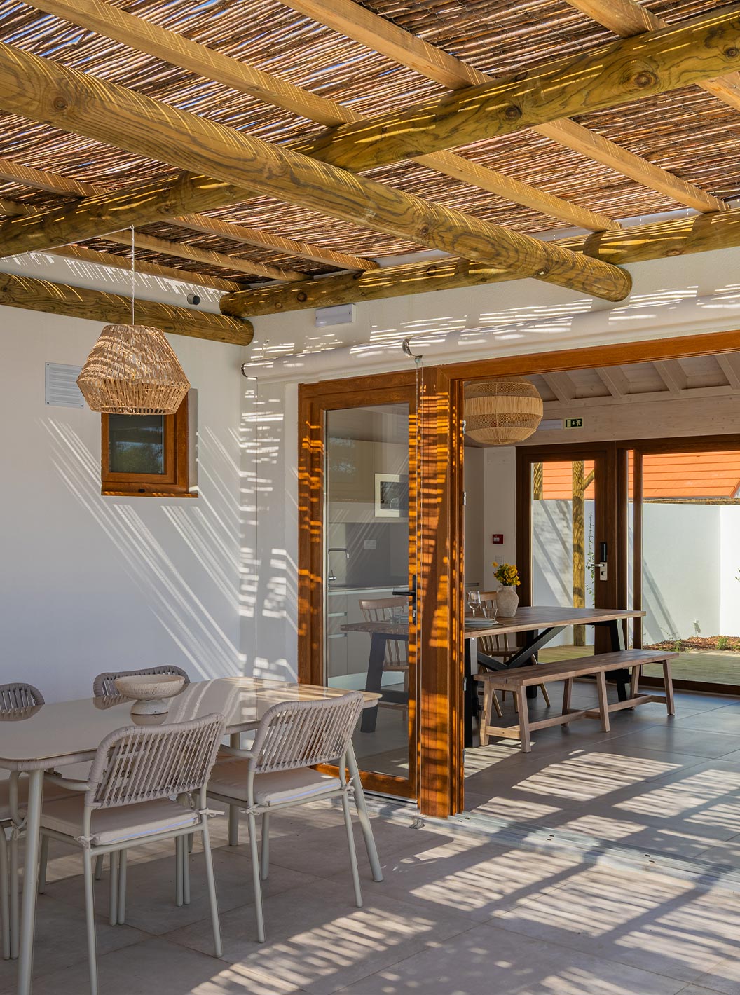The Premium Villa at Pestana Comporta Village Residences has a covered patio with a table leading to the interior