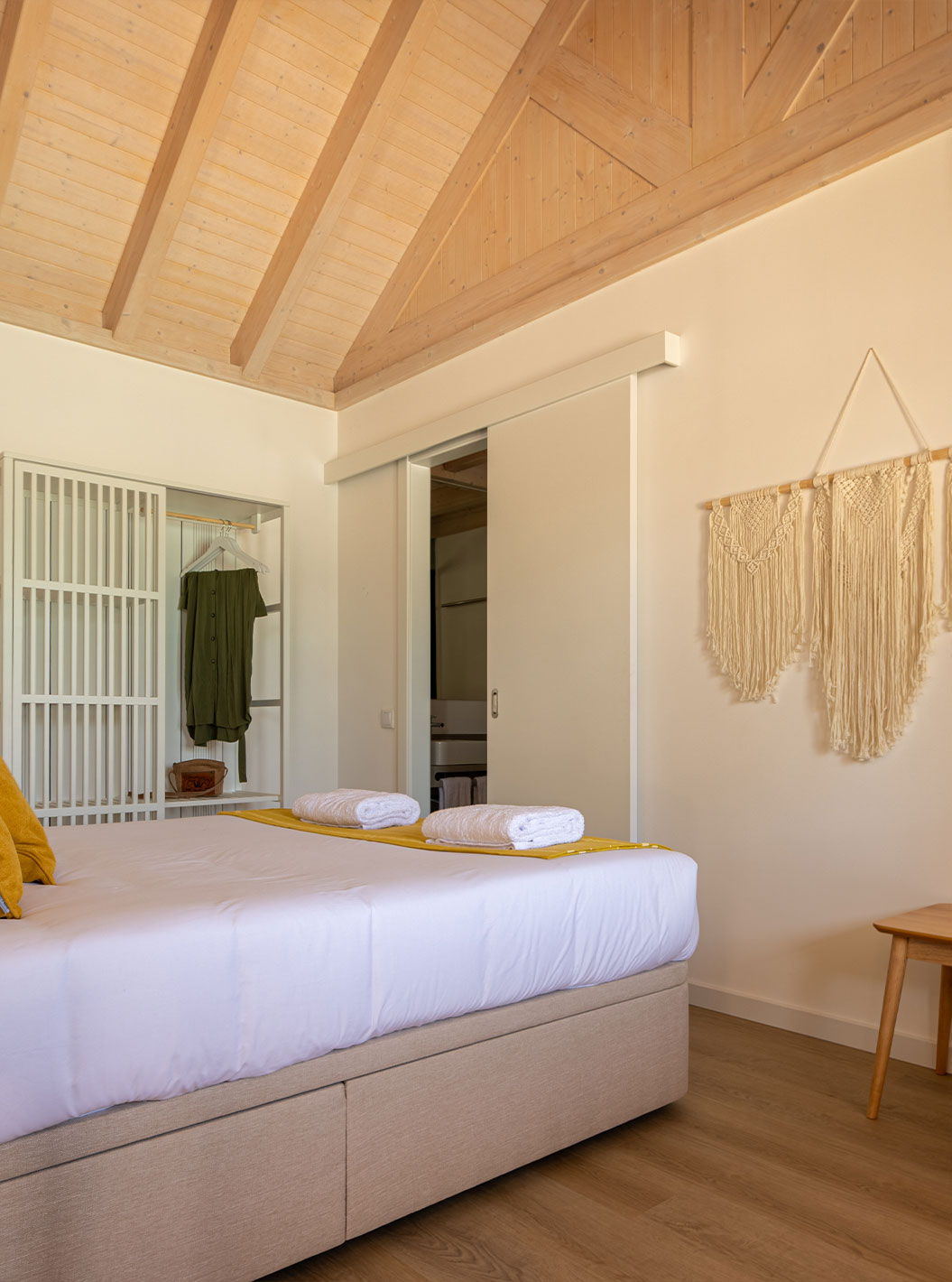 The Standard Green Villa at Pestana Comporta Village Residences has a minimalist bedroom with a bed and a bench