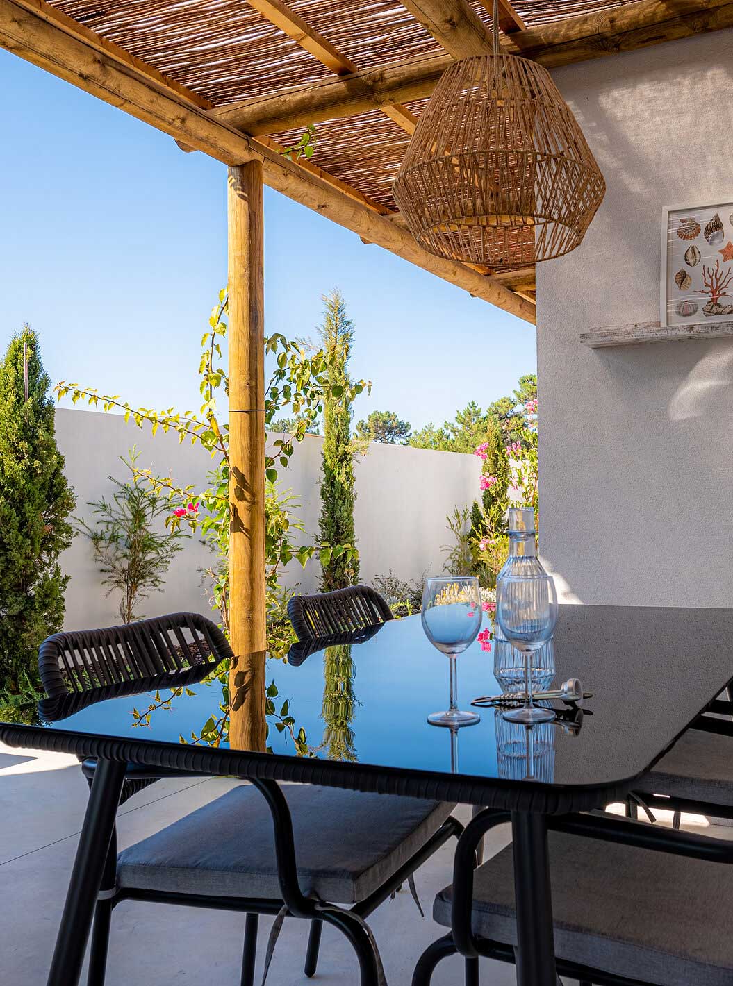 The Standard Green Villa at Pestana Comporta Village Residences has an outdoor dining table under a pergola