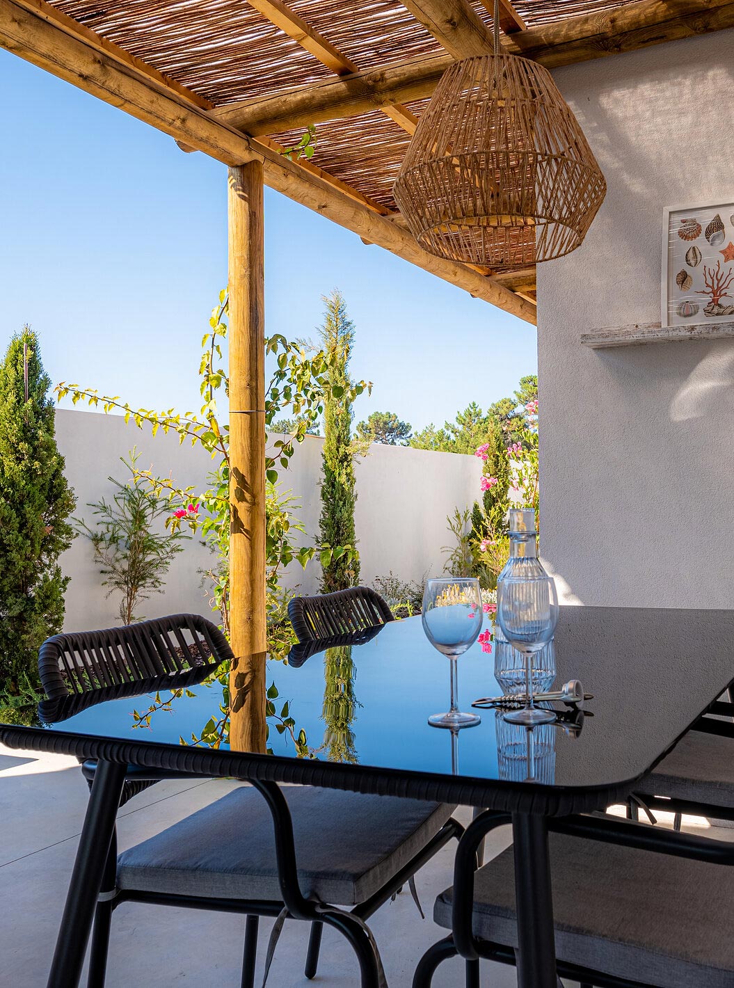 The Standard Villa at Pestana Comporta Village Residences has an outdoor dining table under a pergola