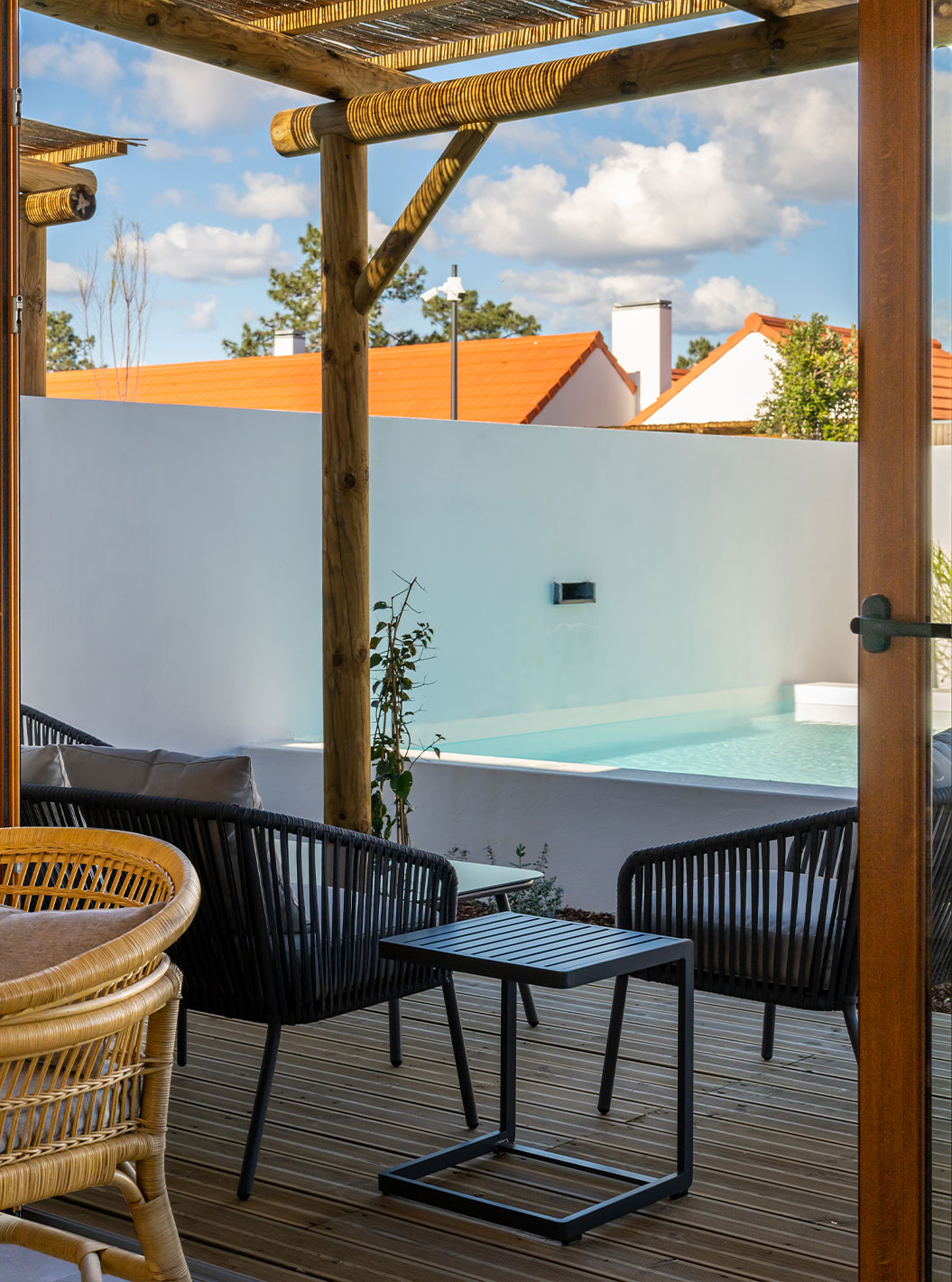 The Superior Villa at Pestana Comporta Village Residences has a terrace with a pool, chairs, and an outdoor table