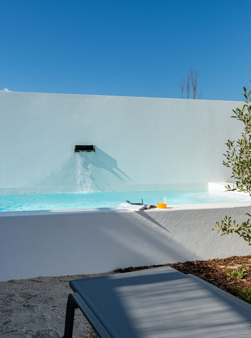 The Superior Villa at Pestana Comporta Village Residences has a pool with a waterfall and several sun loungers
