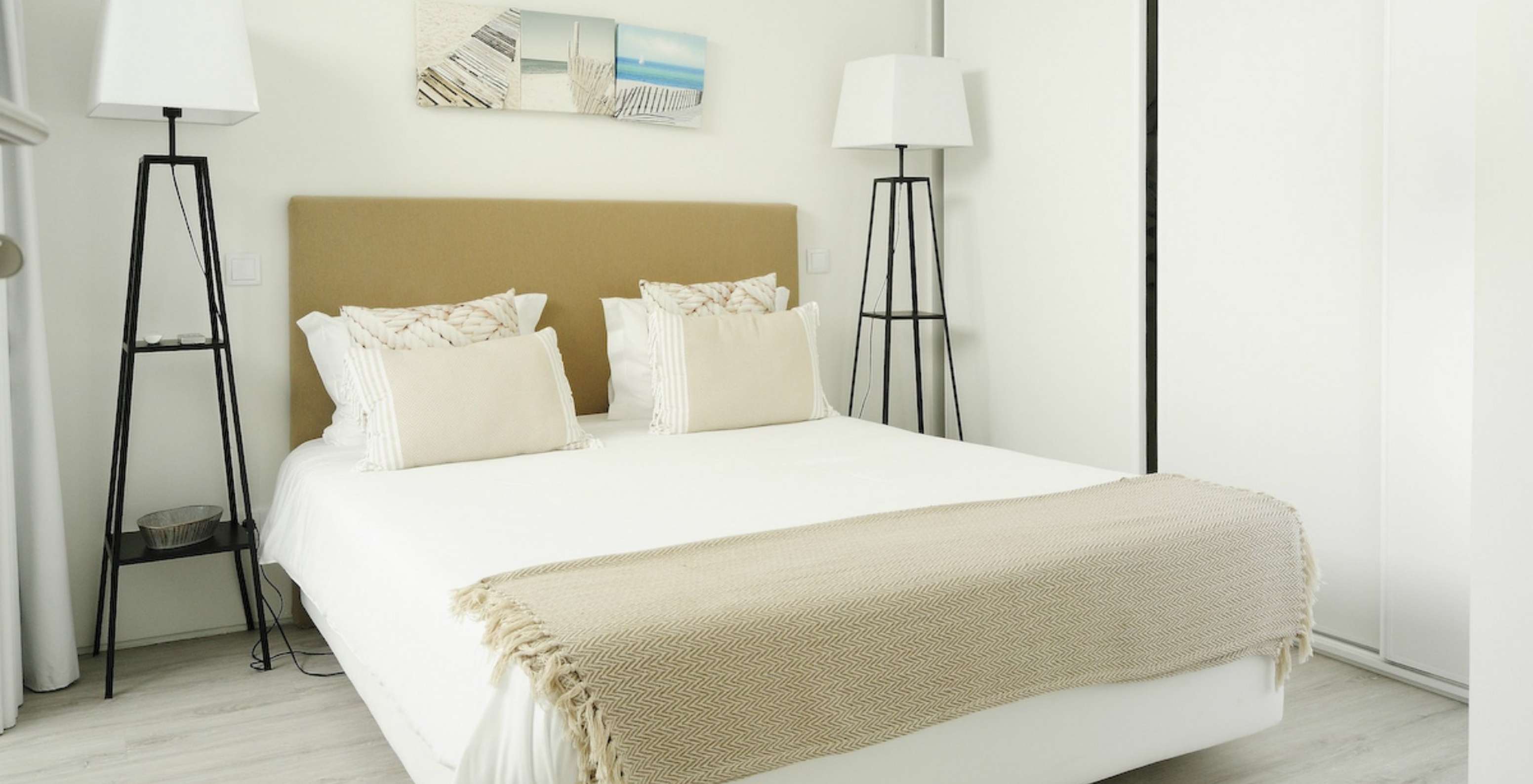 The Green T3 Villa of Pestana Tróia Eco Resort has a double bed with two bedside tables and a beige bedspread
