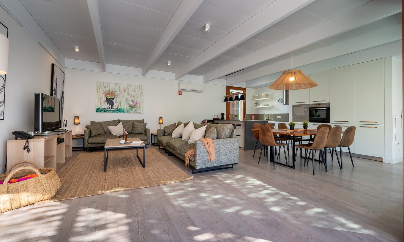 The 4-Bedroom Villas of Pestana Tróia Eco Resort have a large living room connected to the kitchen with sofa and table