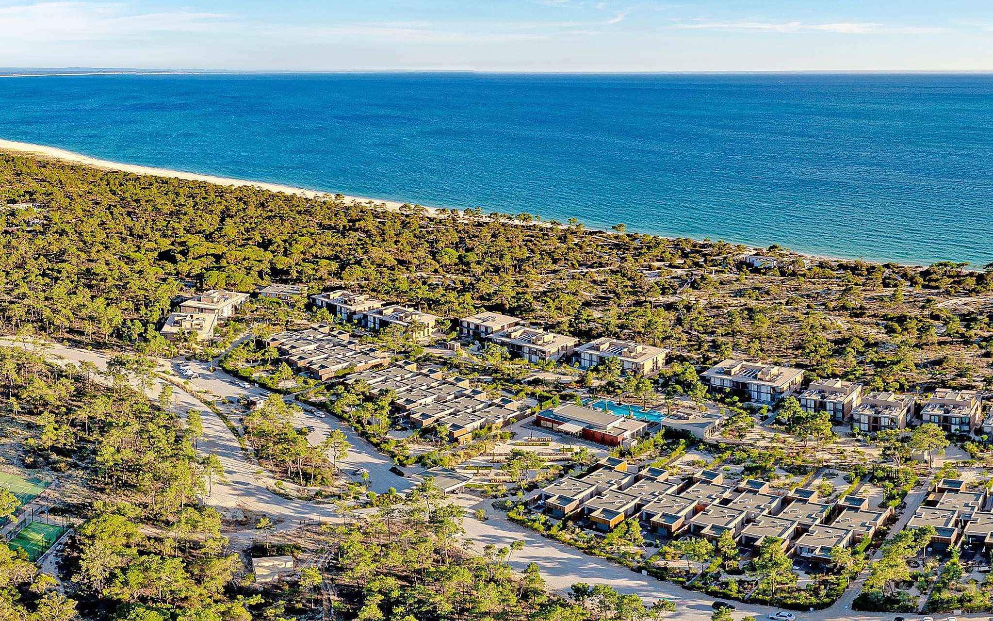 Aerial view of Pestana Tróia Eco Resort, overlooking the various villas, nature, and the sea, near Comporta
