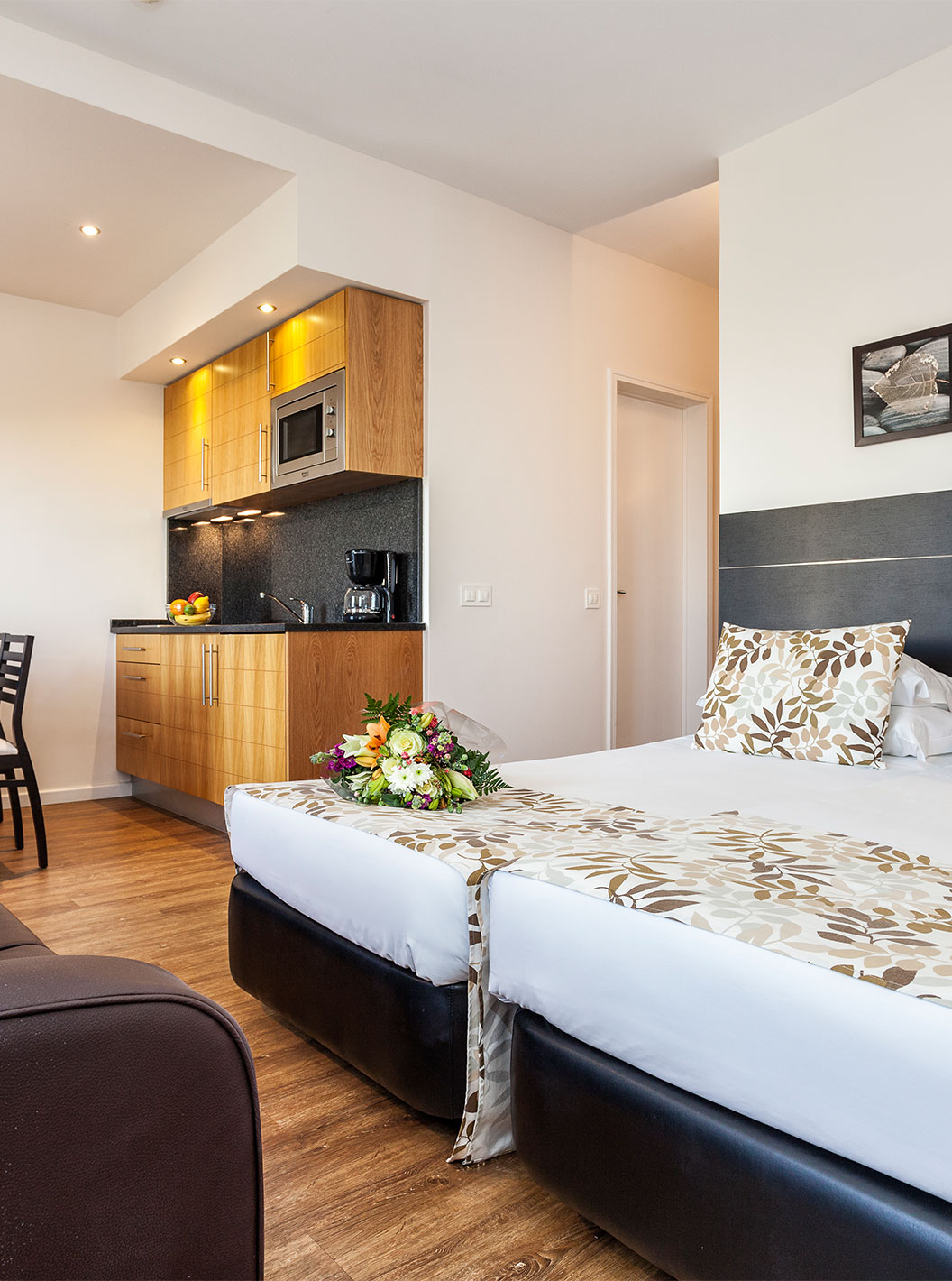 The Garden View Studio at Pestana Alvor Atlântico is an apartment with a bed, sofa, table, and kitchenette