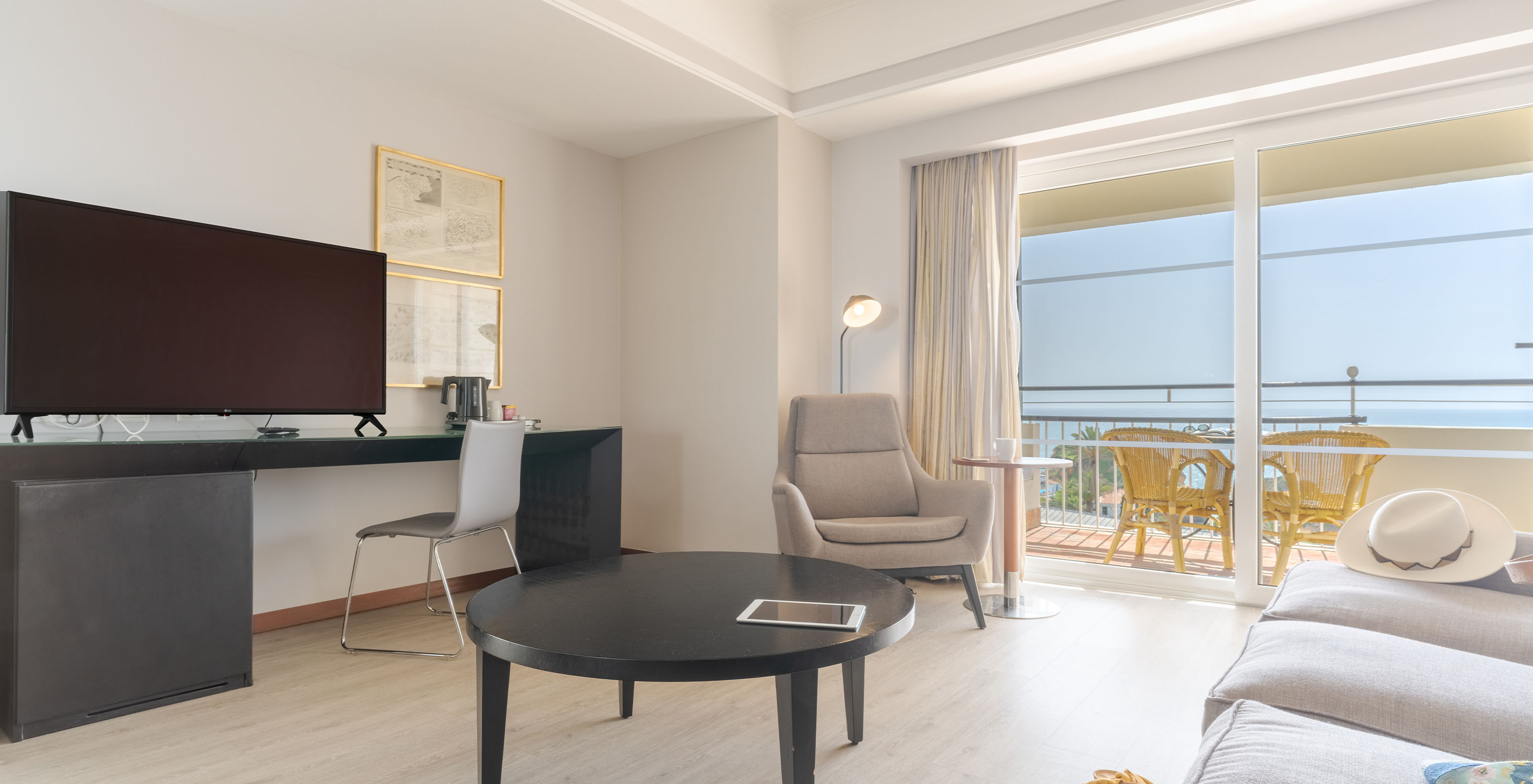 The Sea View Suite at Pestana Alvor Praia has a sofa with a coffee table, a desk with TV, and a sea view