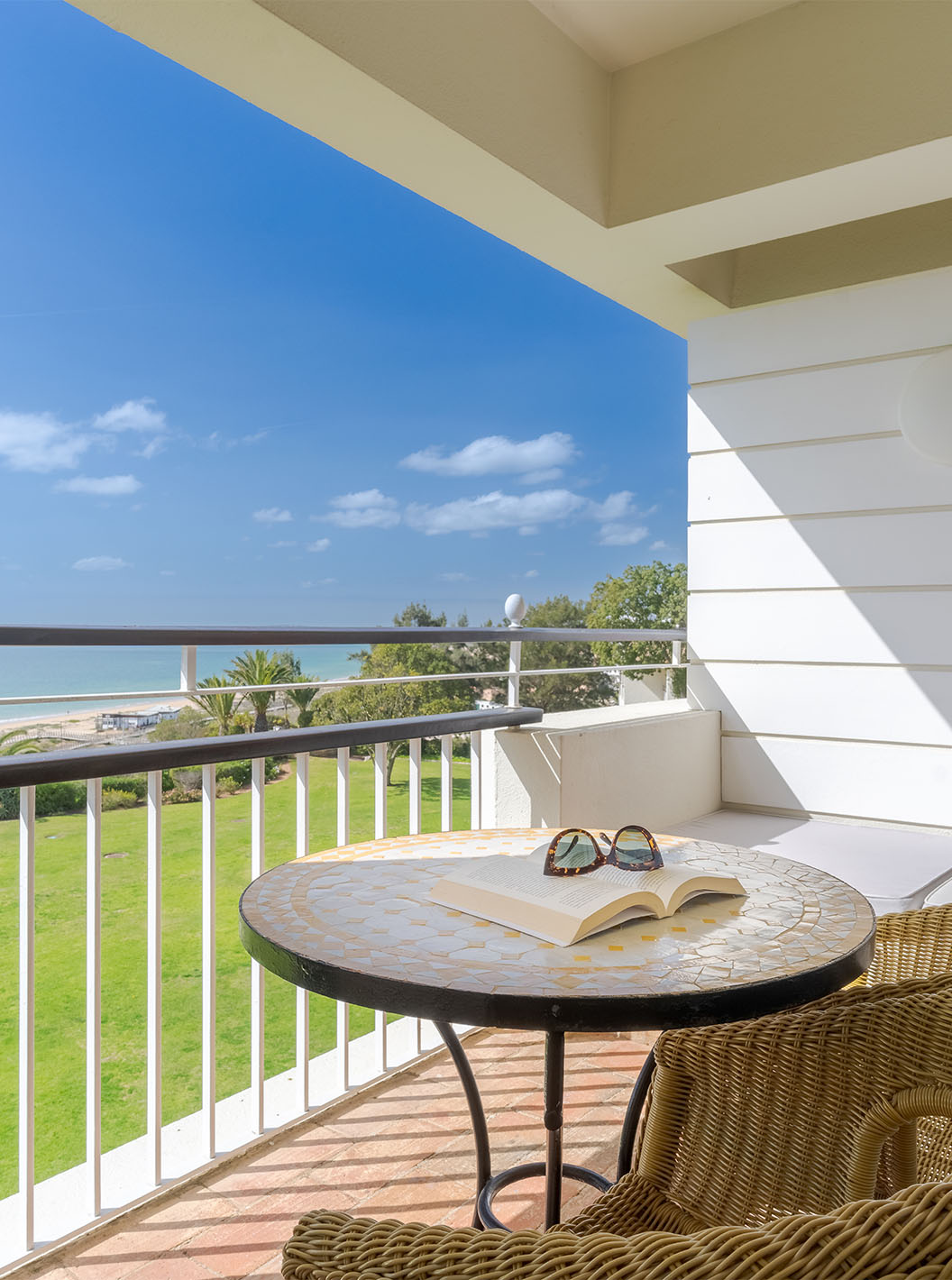 The Sea View Deluxe at Pestana Alvor Praia has a balcony with chairs, a table, and a sofa with sea views