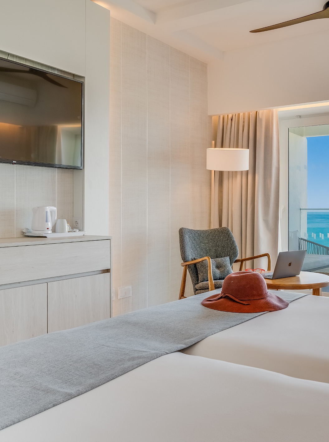 The Family Room at Pestana Blue Alvor Beach has two beds with white sheets and a TV at the end of the bed