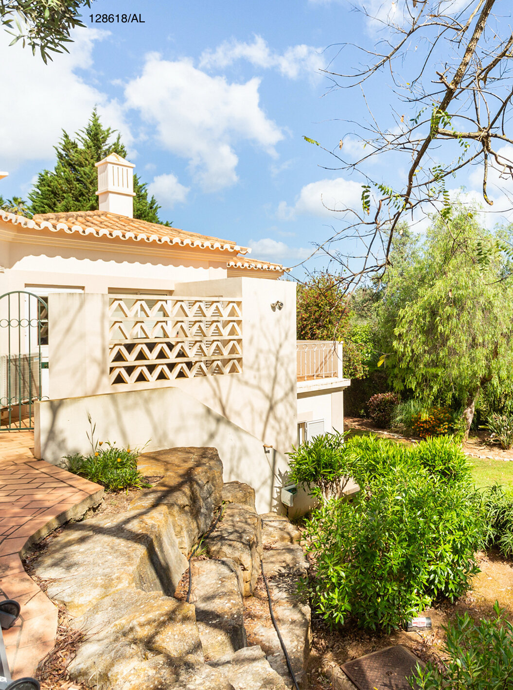 The Pestana Carvoeiro Golf V3 Superior Villa has an exterior patio with grass and trees around it