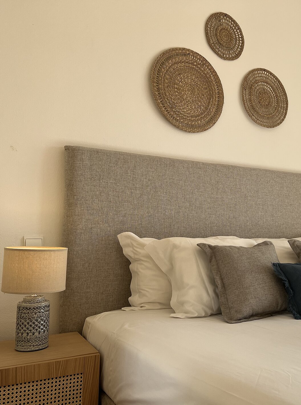 The T1 Apartment Standard do Pestana Palm Gardens has a double bed with decorative pillows and decorative paintings