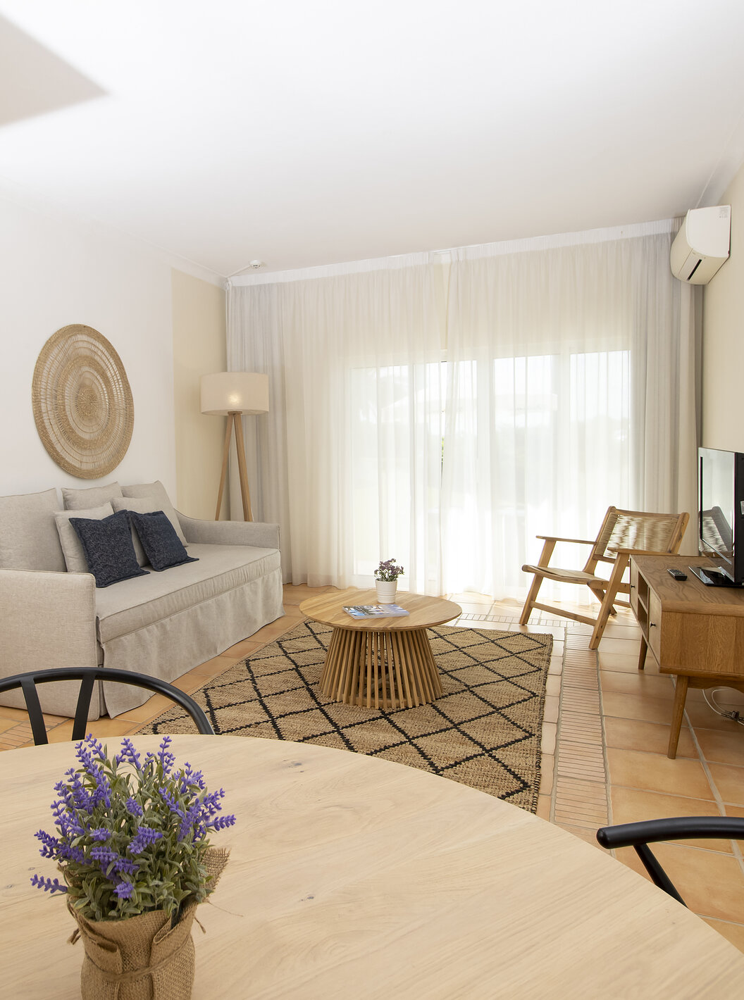 The T2 Apartment Superior do Pestana Palm Gardens has a room with a round table, sofa, TV and window to the garden