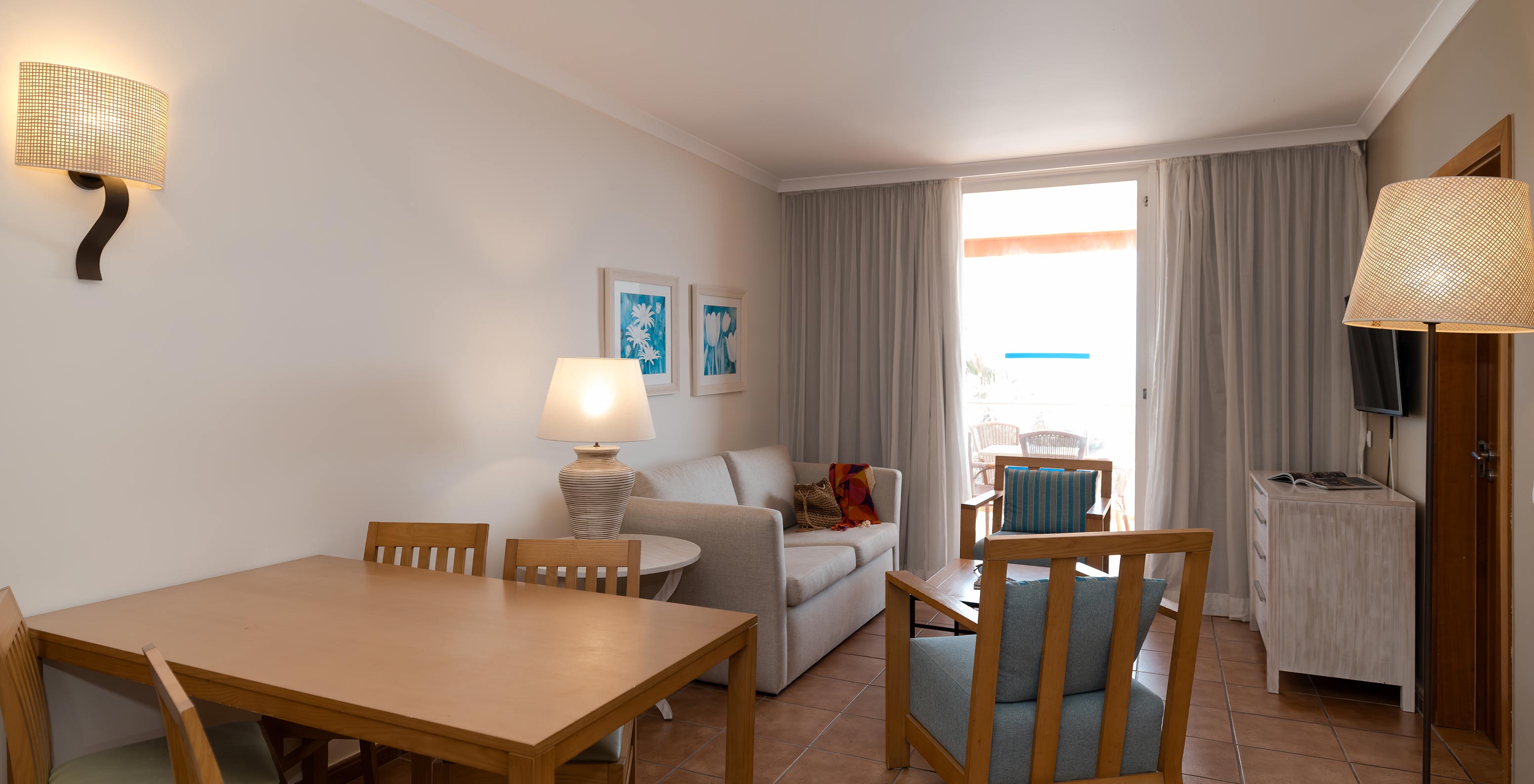 The T2 Suite at Pestana Viking has a living room with sofa, two armchairs and window with balcony access