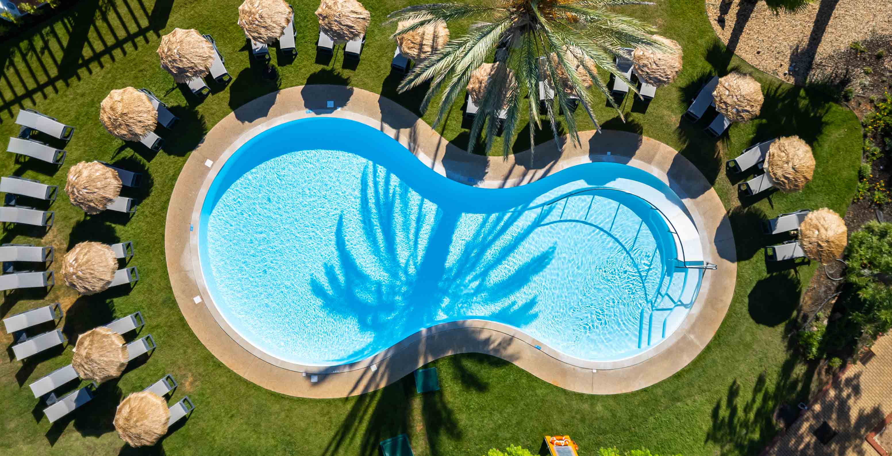 View of the pool at Pestana Vila Sol - Vilamoura, a hotel with golf and spa in the Algarve, surrounded by sun loungers