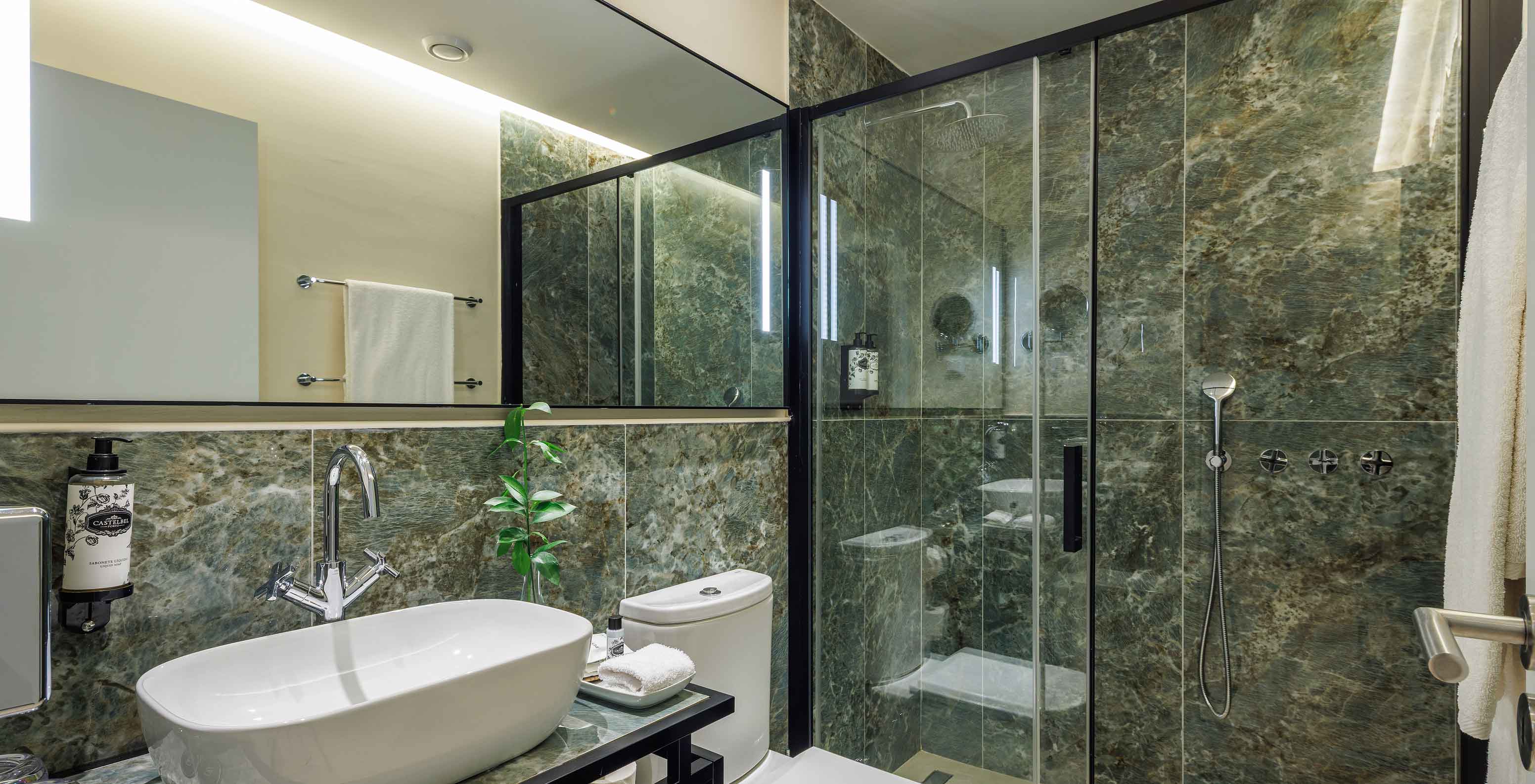 The Classic Garden View at Pestana Vila Sol - Vilamoura has a green marble bathroom with toilet, sink and shower