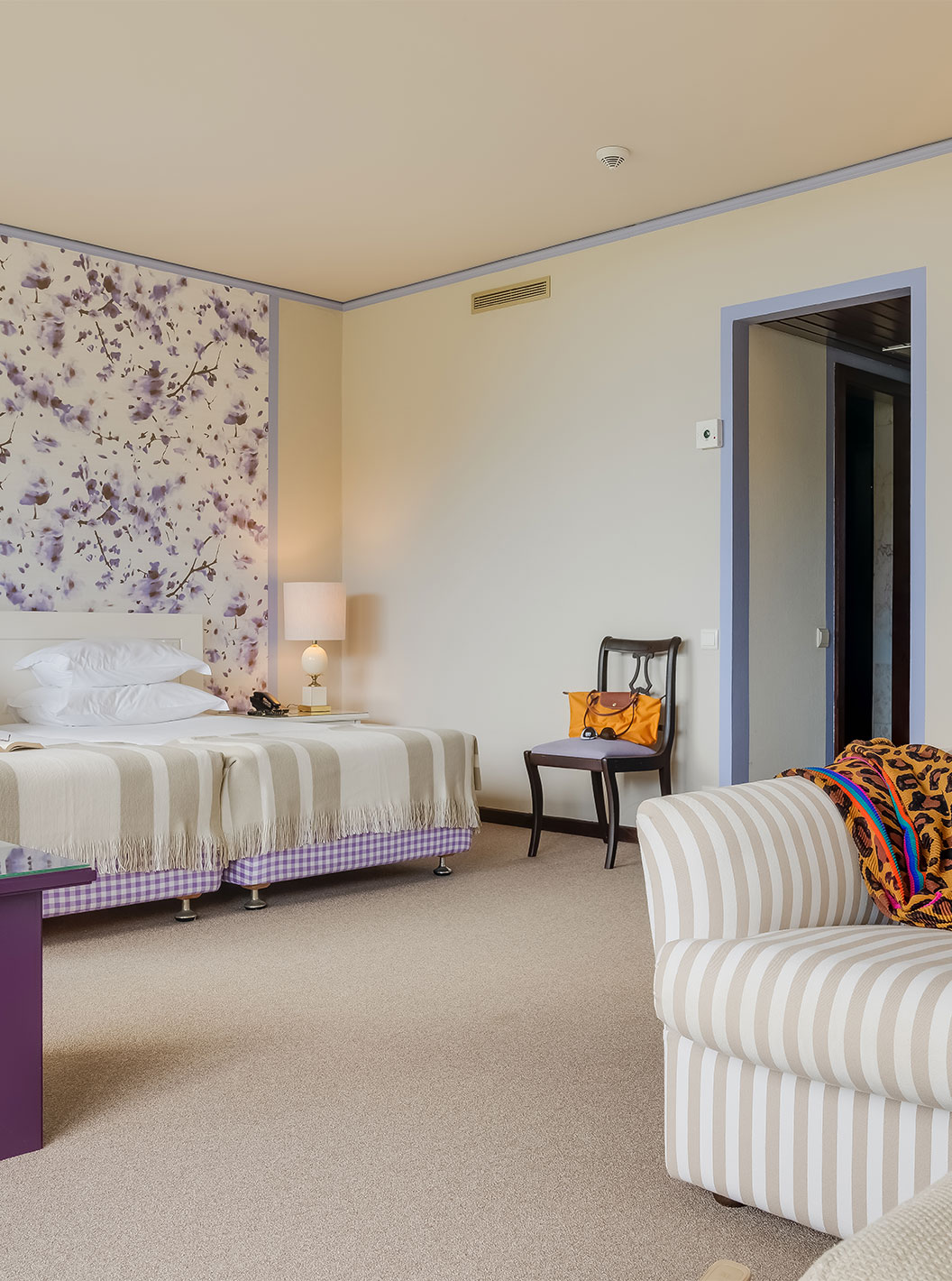 Junior Garden View Suite at Pestana Bahia Praia has a spacious area with two single beds, a sofa and a chair