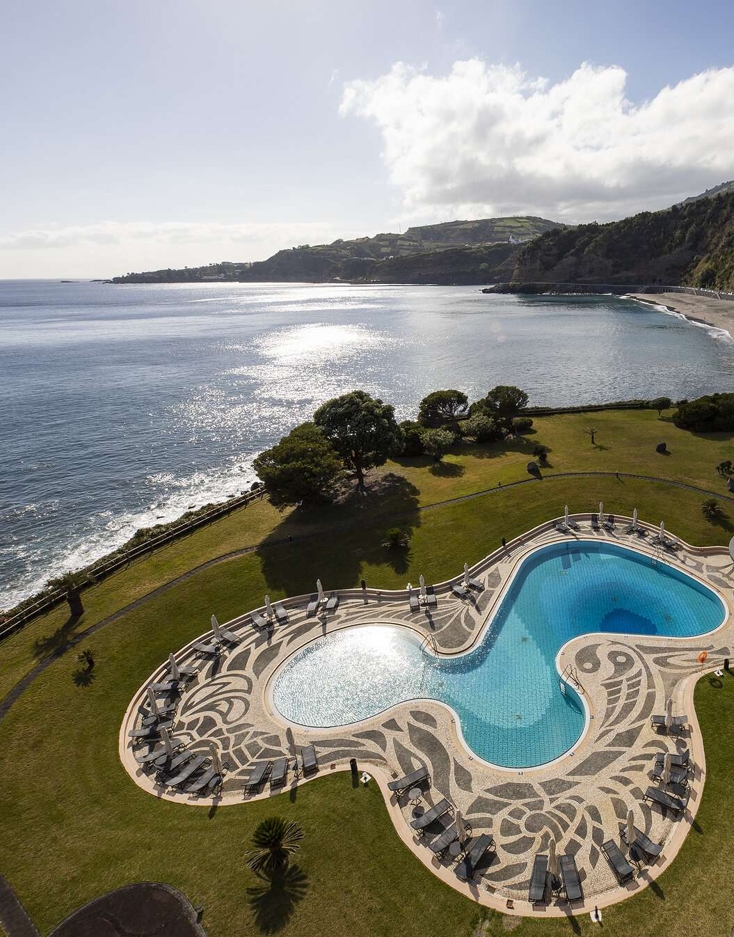 Pool with sea and beach view at Pestana Bahia Praia in São Miguel on a partly cloudy day