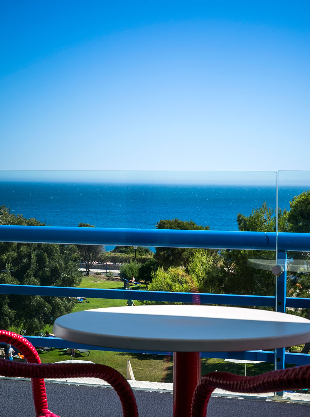 The Deluxe Sea View room at Pestana Cascais has a balcony with a table and chairs with a view of the sea