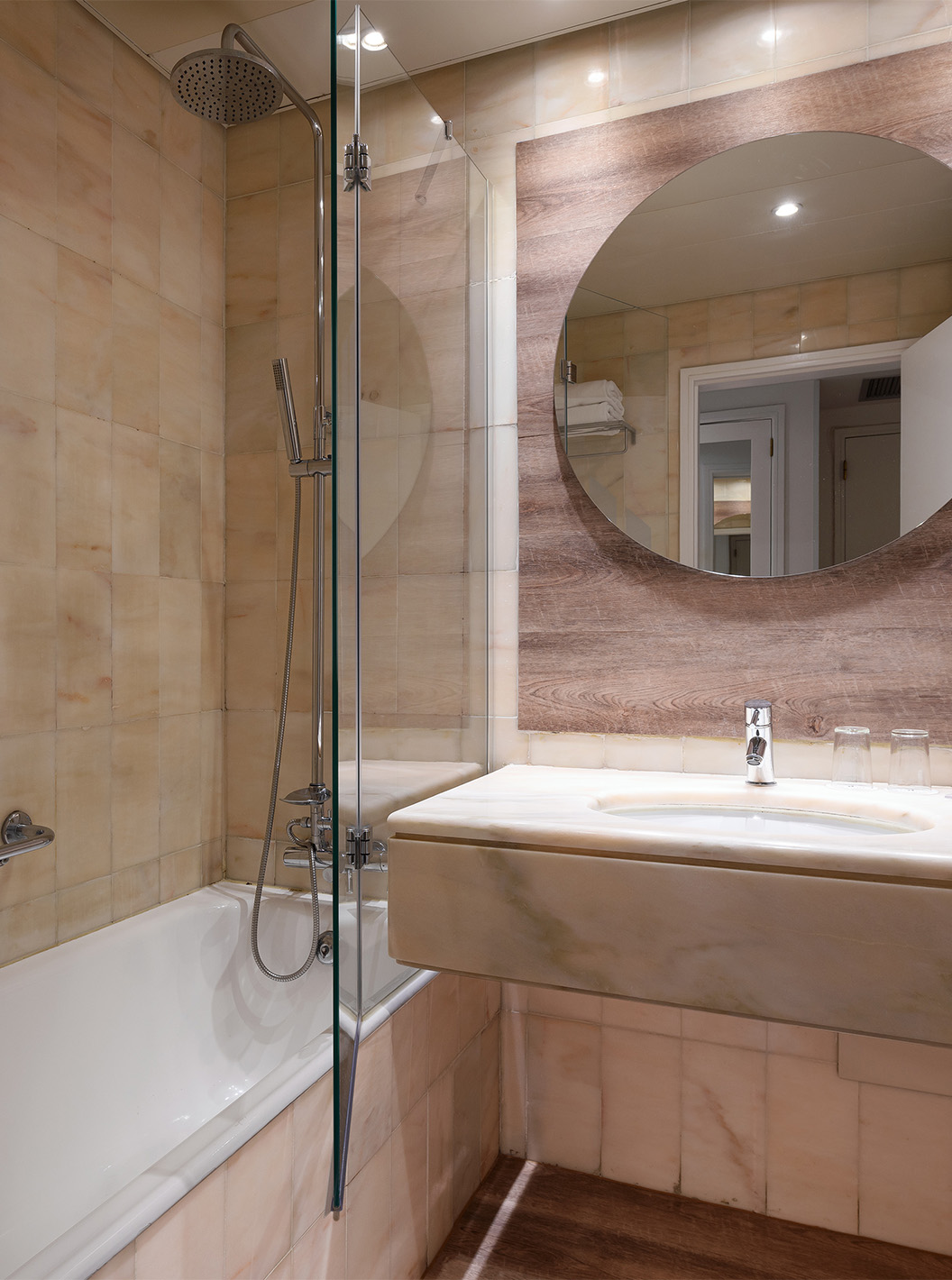 The Superior Deluxe Sea View room at Pestana Cascais has a bathroom with a mirror, sink, and bathtub with a shower