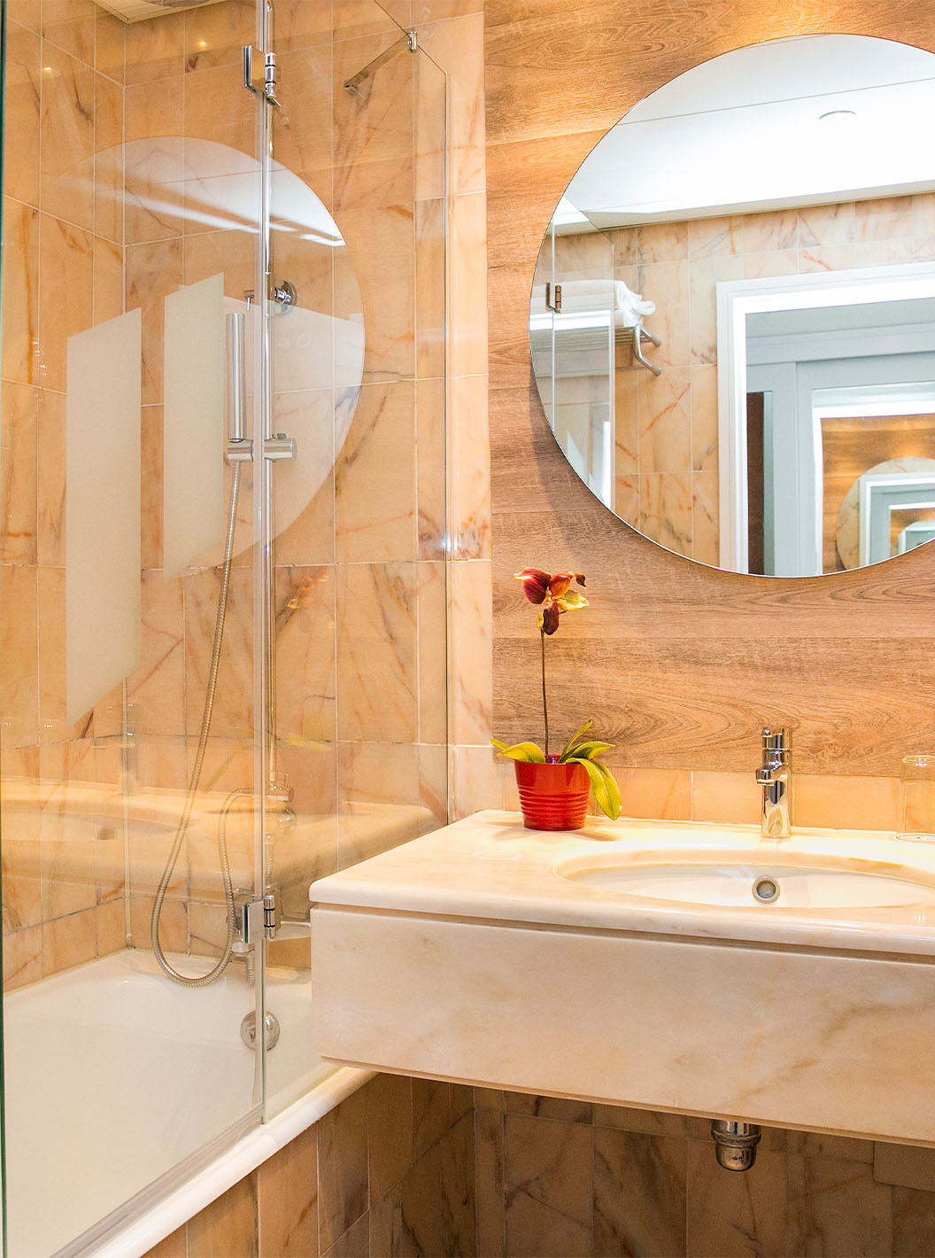 The Deluxe Suite at Pestana Cascais has a bathroom with a mirror, sink, and bathtub with a shower