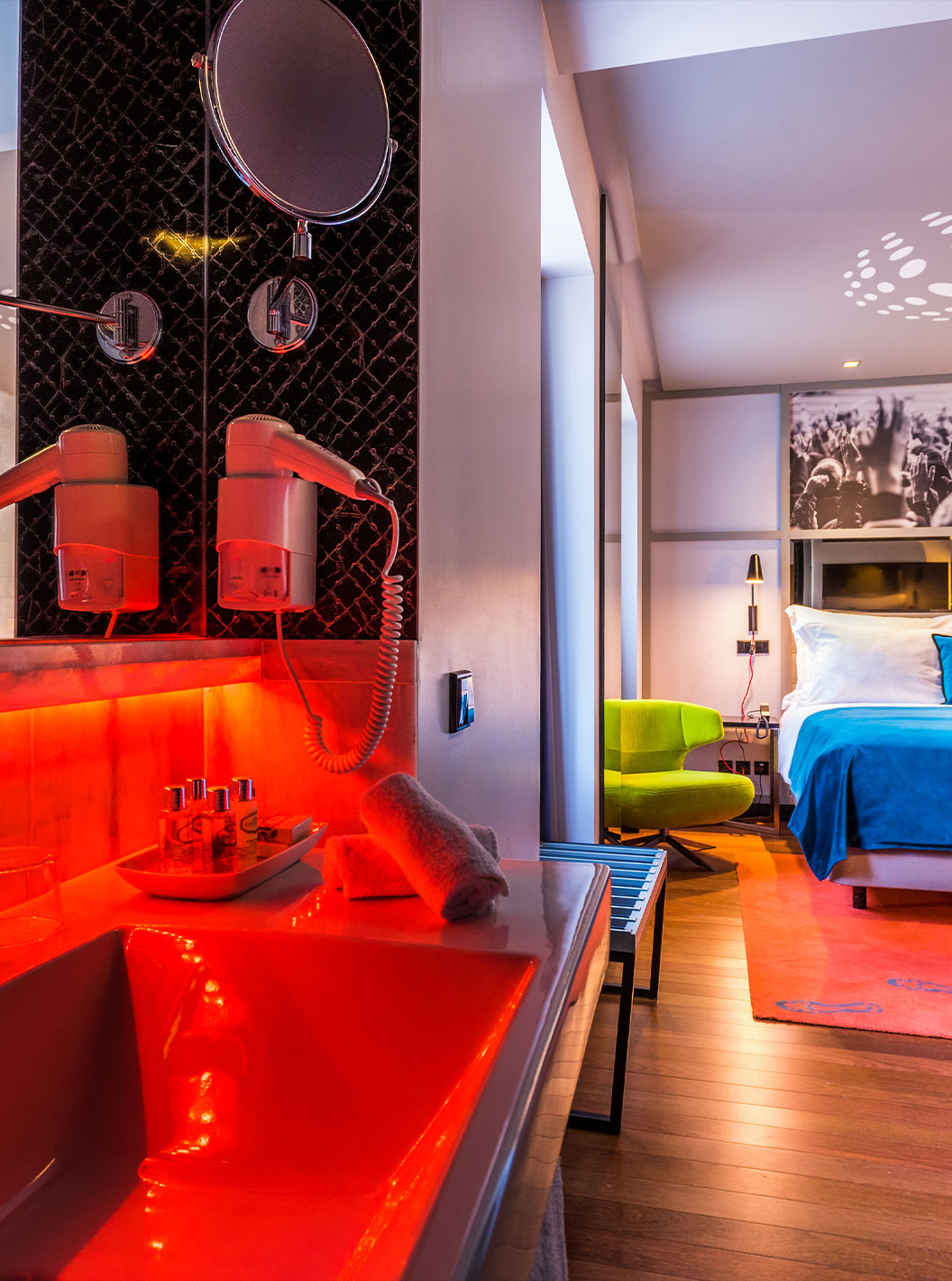 The CR7 Room at Pestana CR7 Lisboa features a double bed and a bathroom with sink, mirror, and hairdryer