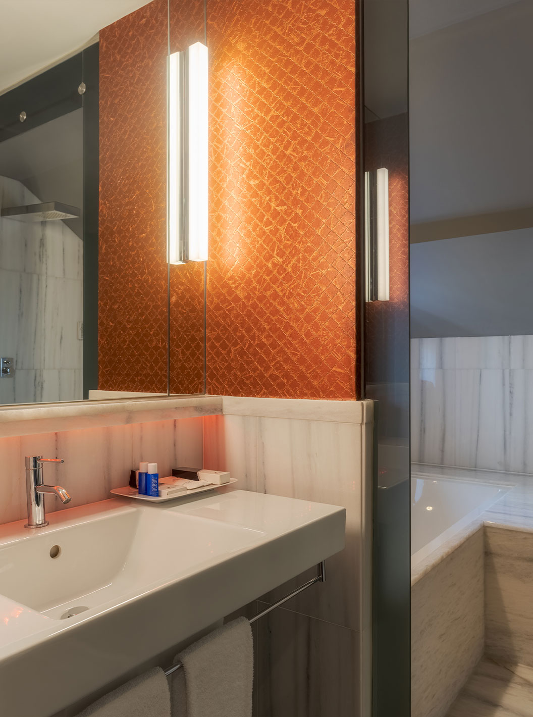 The CR7 Suite at Pestana CR7 Lisboa includes a bathroom with mirror, sink, and bathtub with shower