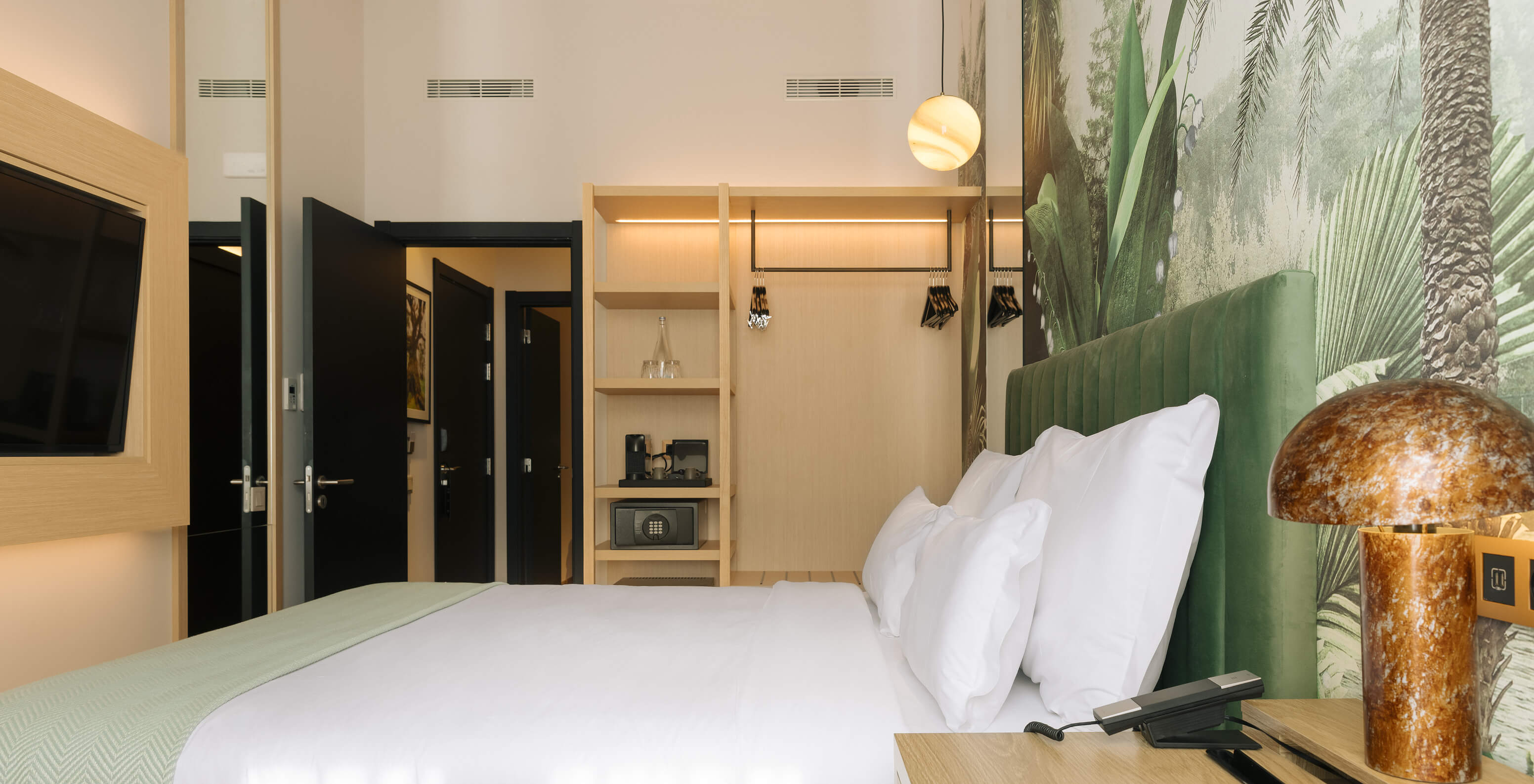 The Family Suite at the Pestana Rua Augusta Lisboa has a double bed with a TV in front and a window with curtains