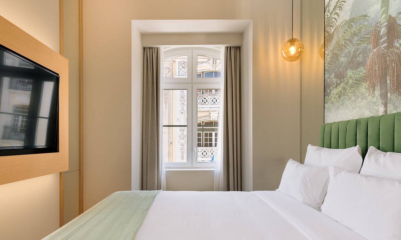 The Superior Room of Pestana Rua Augusta Lisboa has a double bed, television, and a window with city view