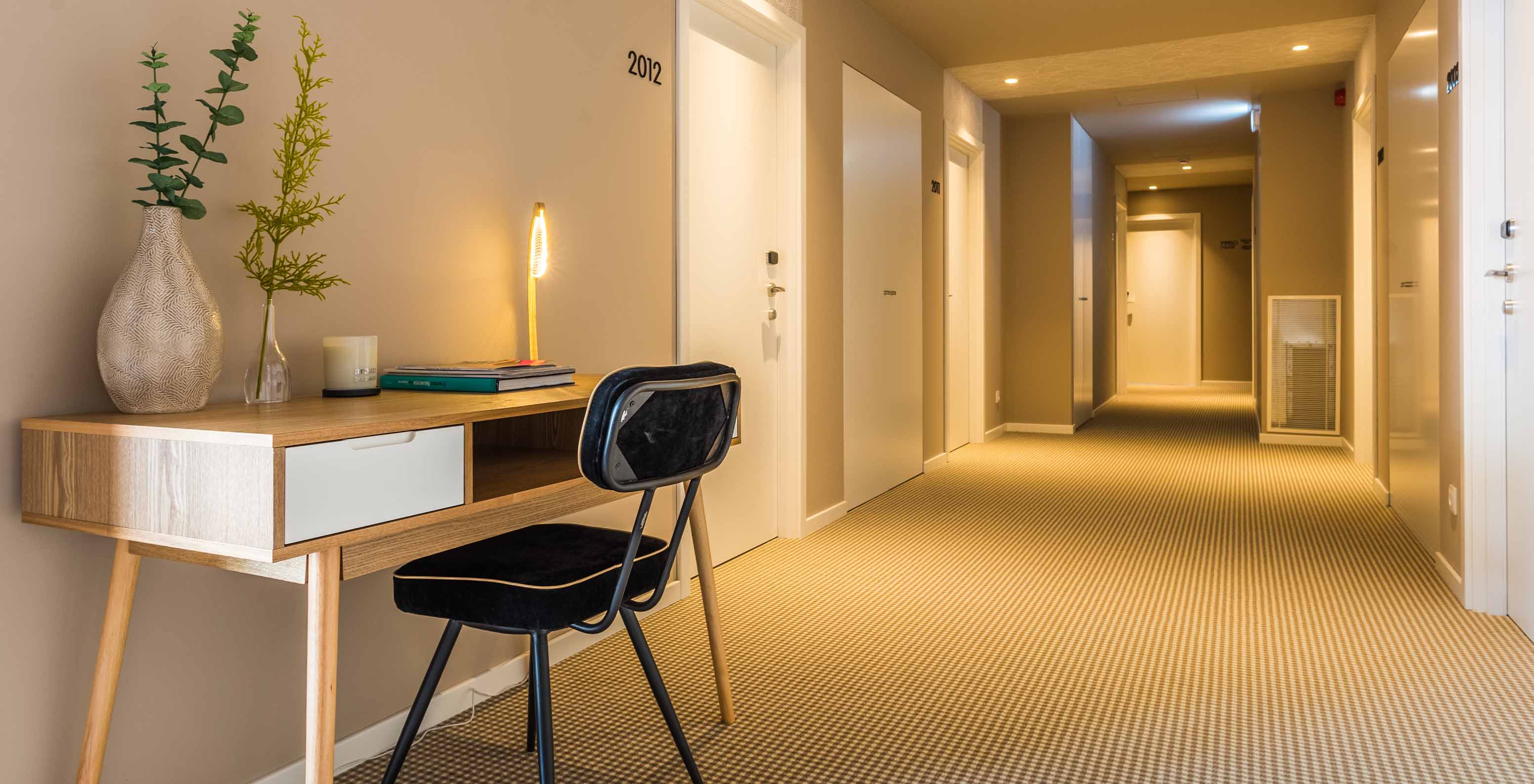 Pestana Casino Studios, with Apartments in the City Center, has a corridor with a desk