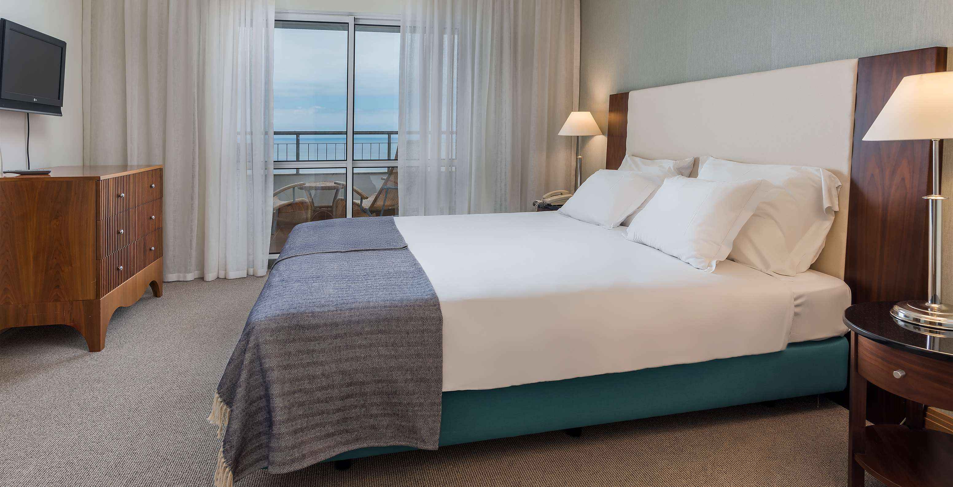 The Master Suite Sea View at Pestana Grand has a double bed with TV and balcony