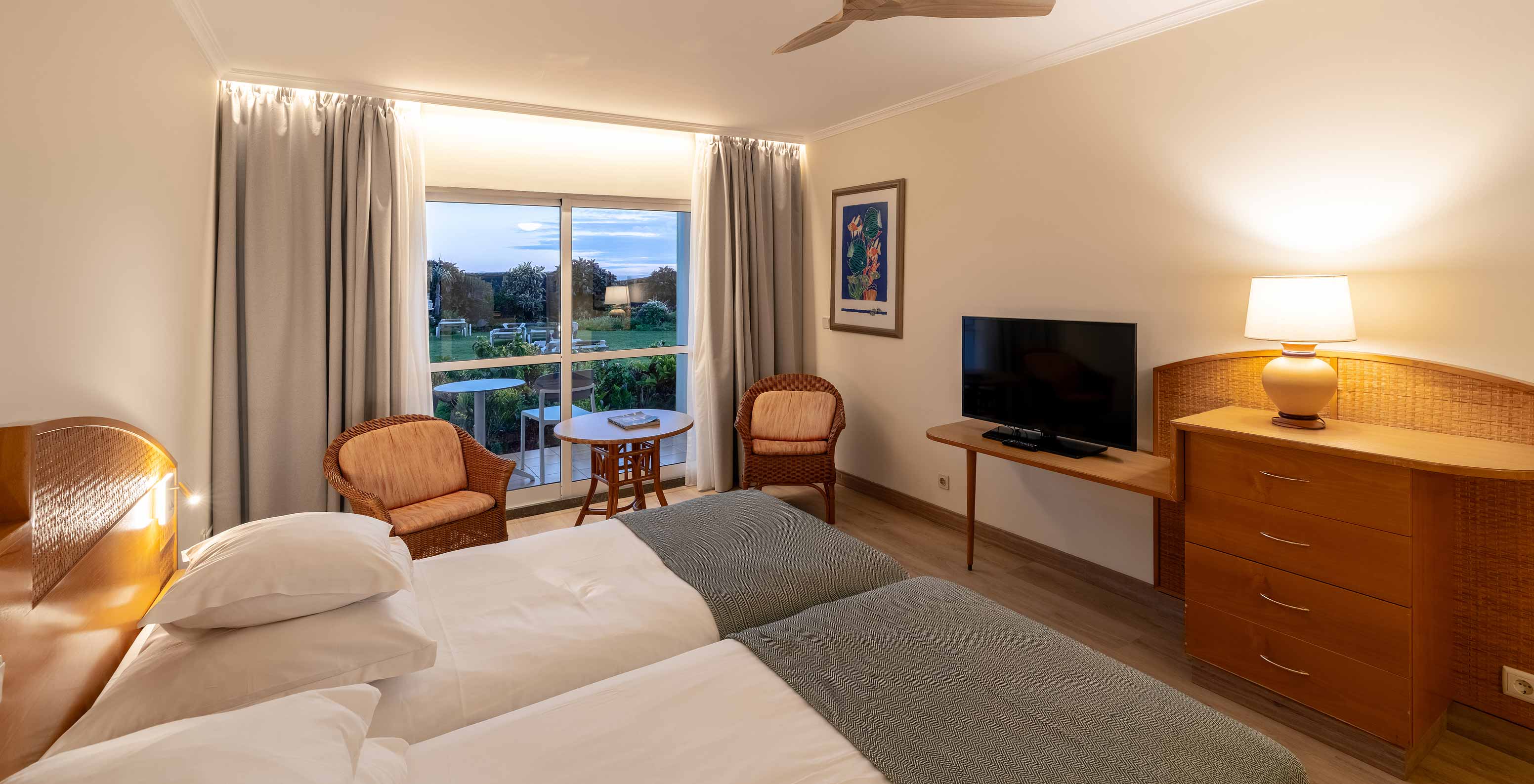 The Pestana Ocean Bay All Inclusive Classic Pool View has two single beds joined together, a garden view, and a TV cabinet