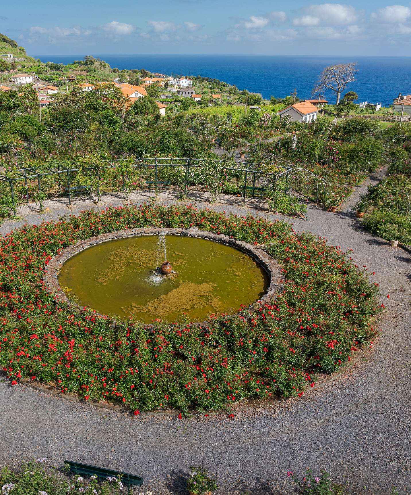 Bird's eye view of the rose garden at Quinta do Arco with the fountain in the center surrounded by various flowers