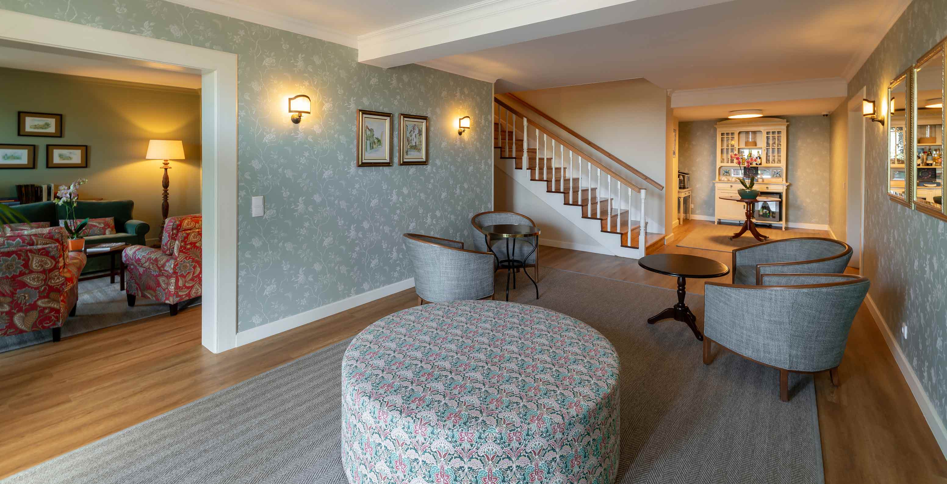 Living room of Pestana Quinta Perestrello with wallpaper, sofas, armchairs, and coffee area
