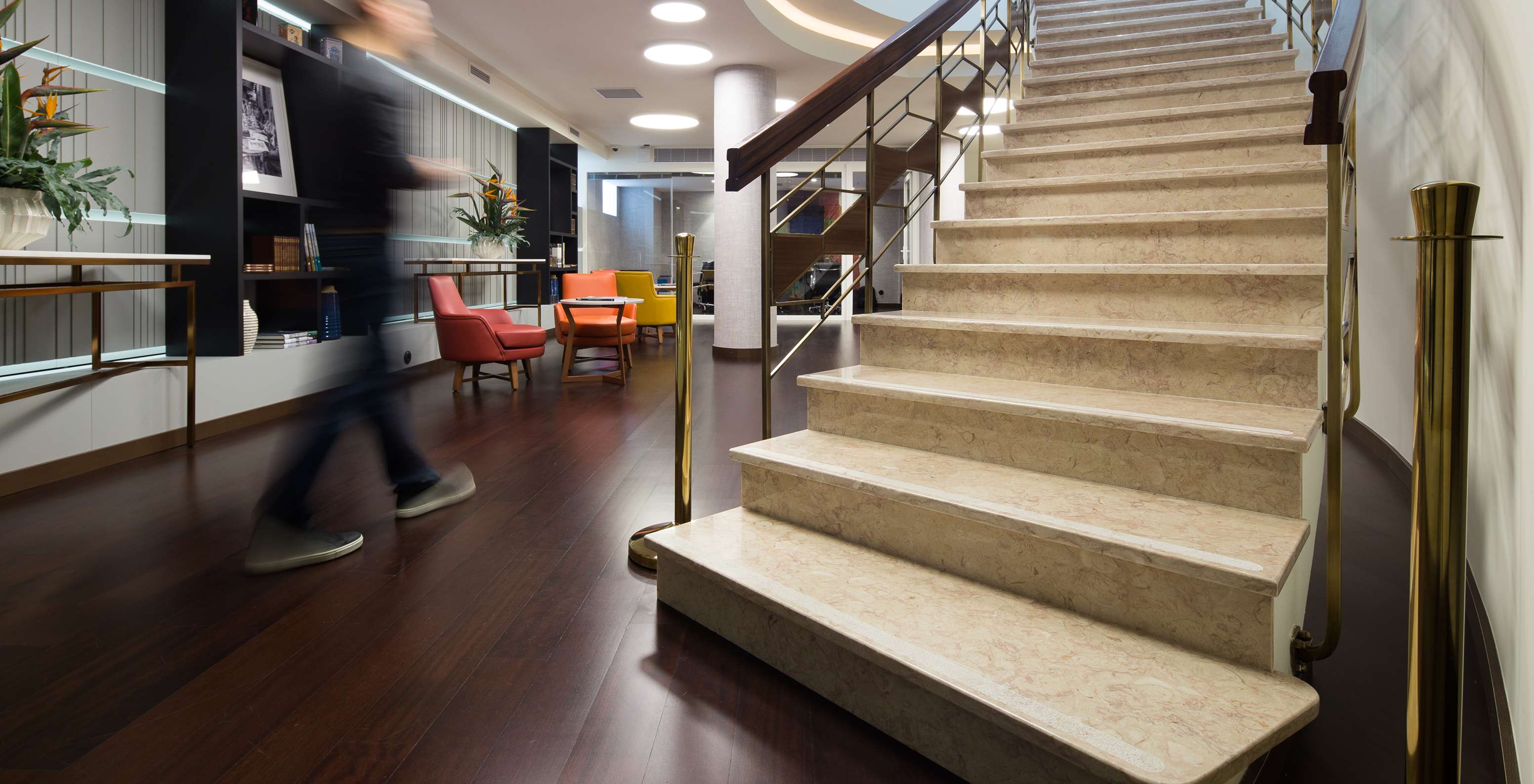 In the lobby of the hotel, there are stone stairs leading to a small leisure space where guests can socialize