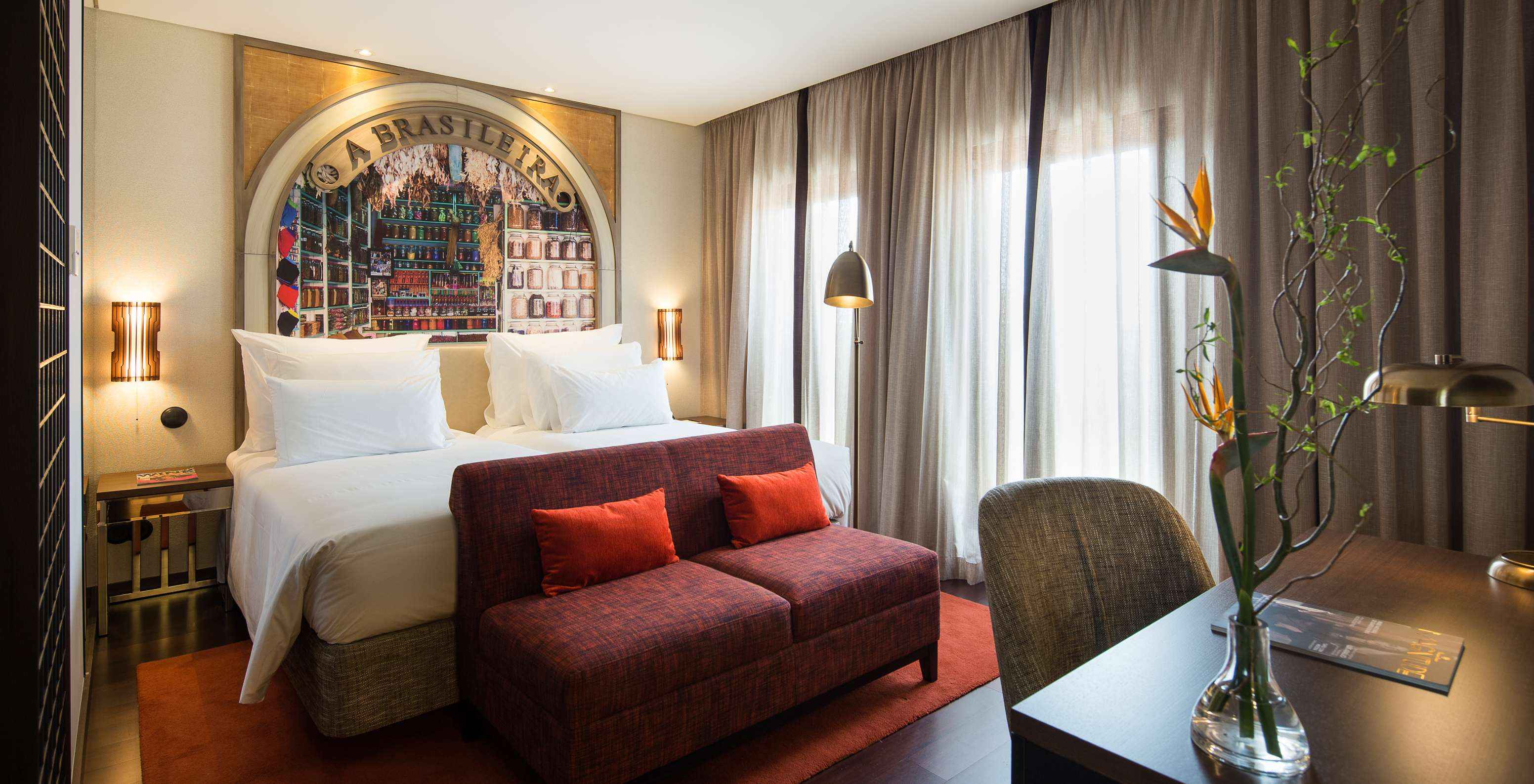 The Deluxe Superior Grand View do Pestana Porto - A Brasileira has a double bed with a sofa at the back and a desk