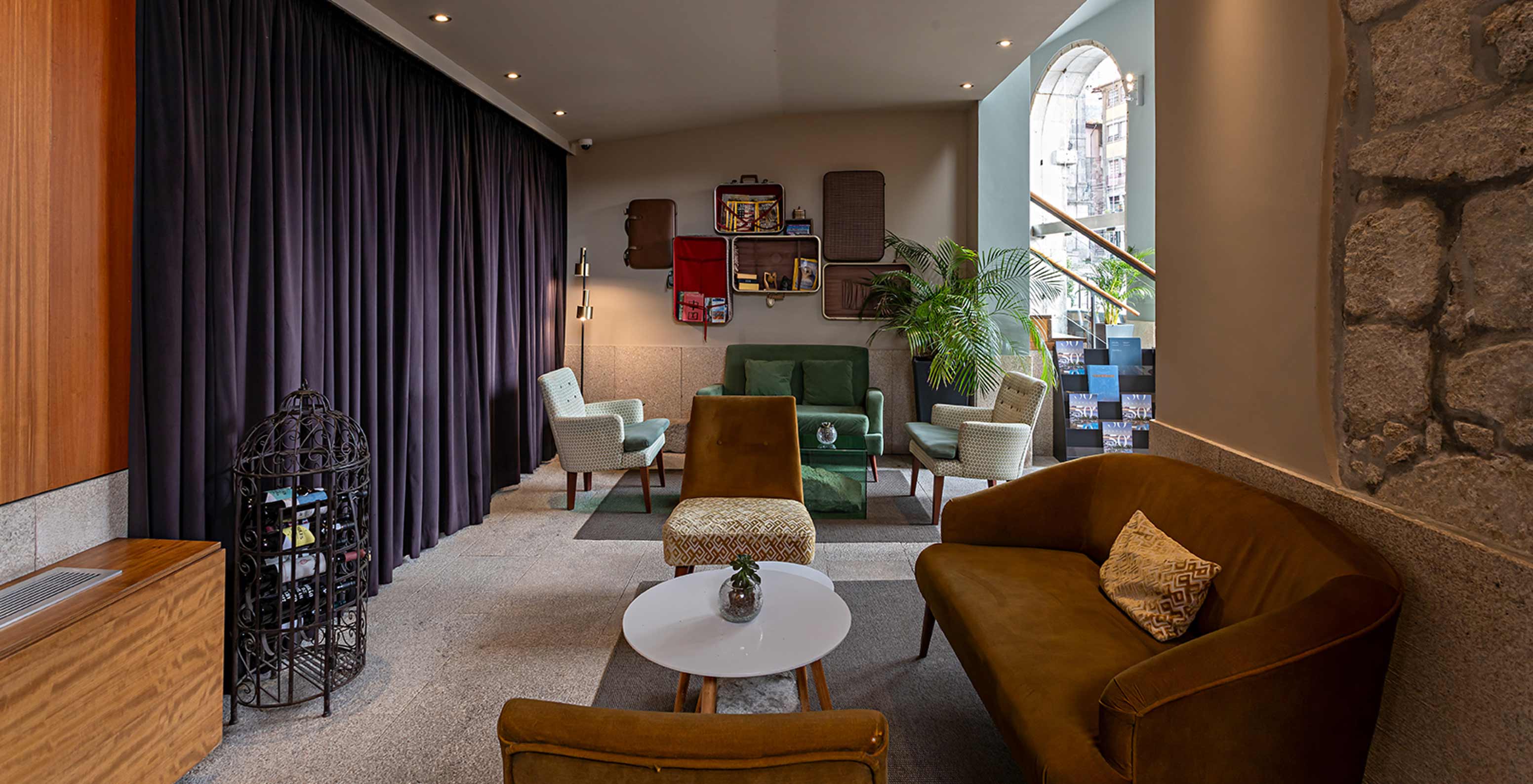 Pestana Vintage Porto has a living room with several armchairs and a sofa, Hotel at Praça da Ribeira, in Porto