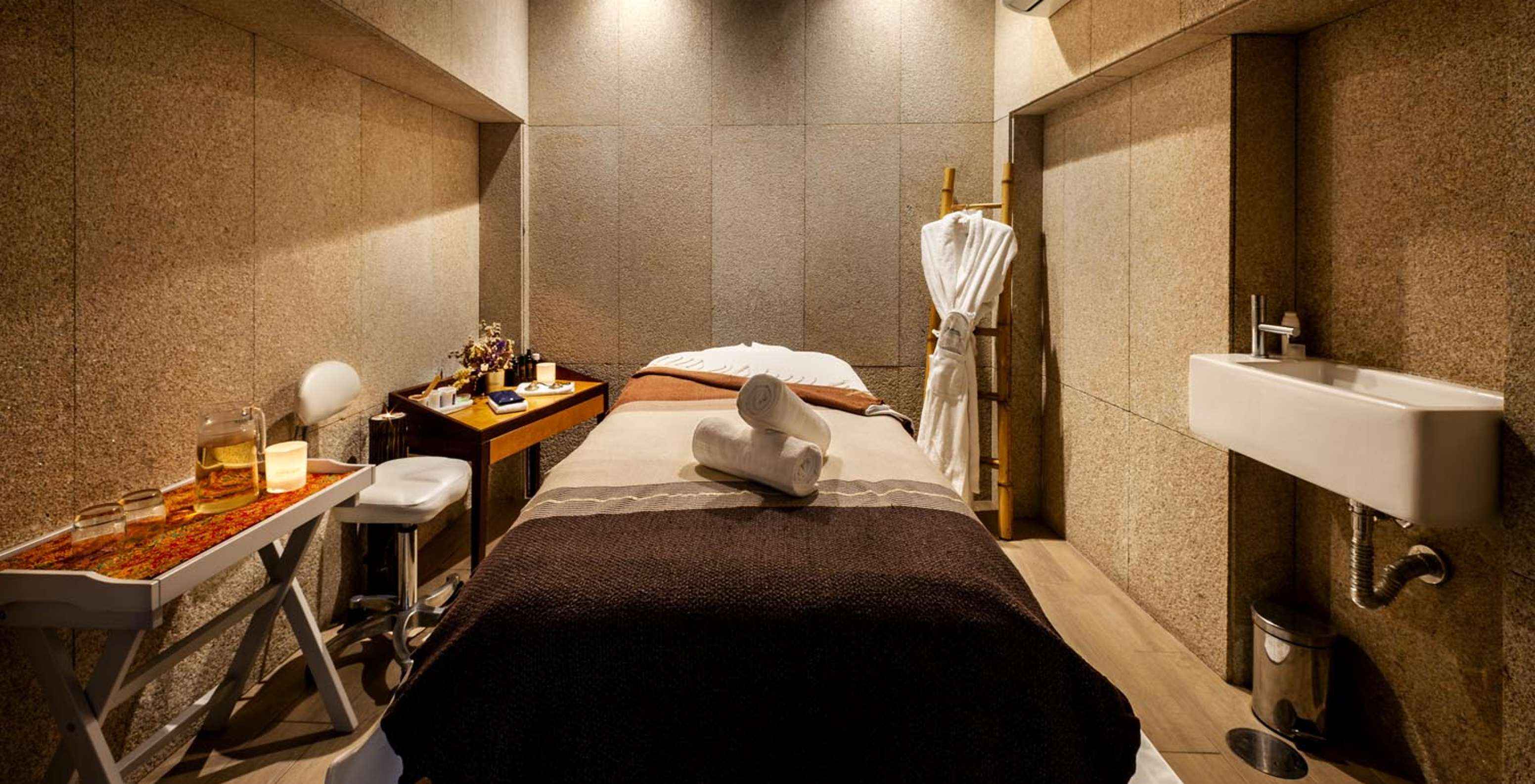 Wellness center bed with a tea table at Pestana Vintage Porto, a hotel at Praça da Ribeira in Porto